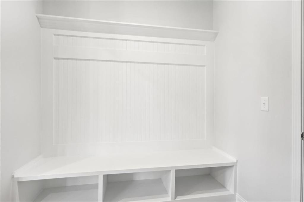 White shiplap mudroom bench with storage cubbies in Davidson Homes The Hickory C, Hoschton, Georgia