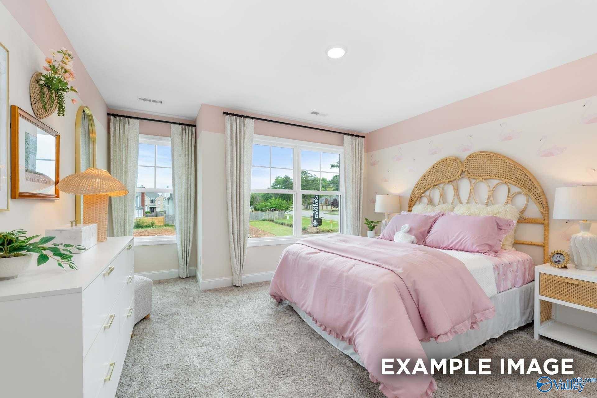 Charming pink girl's bedroom with rattan headboard bed, sheer curtains, and garden view in Davidson Homes The Camden B, Huntsville