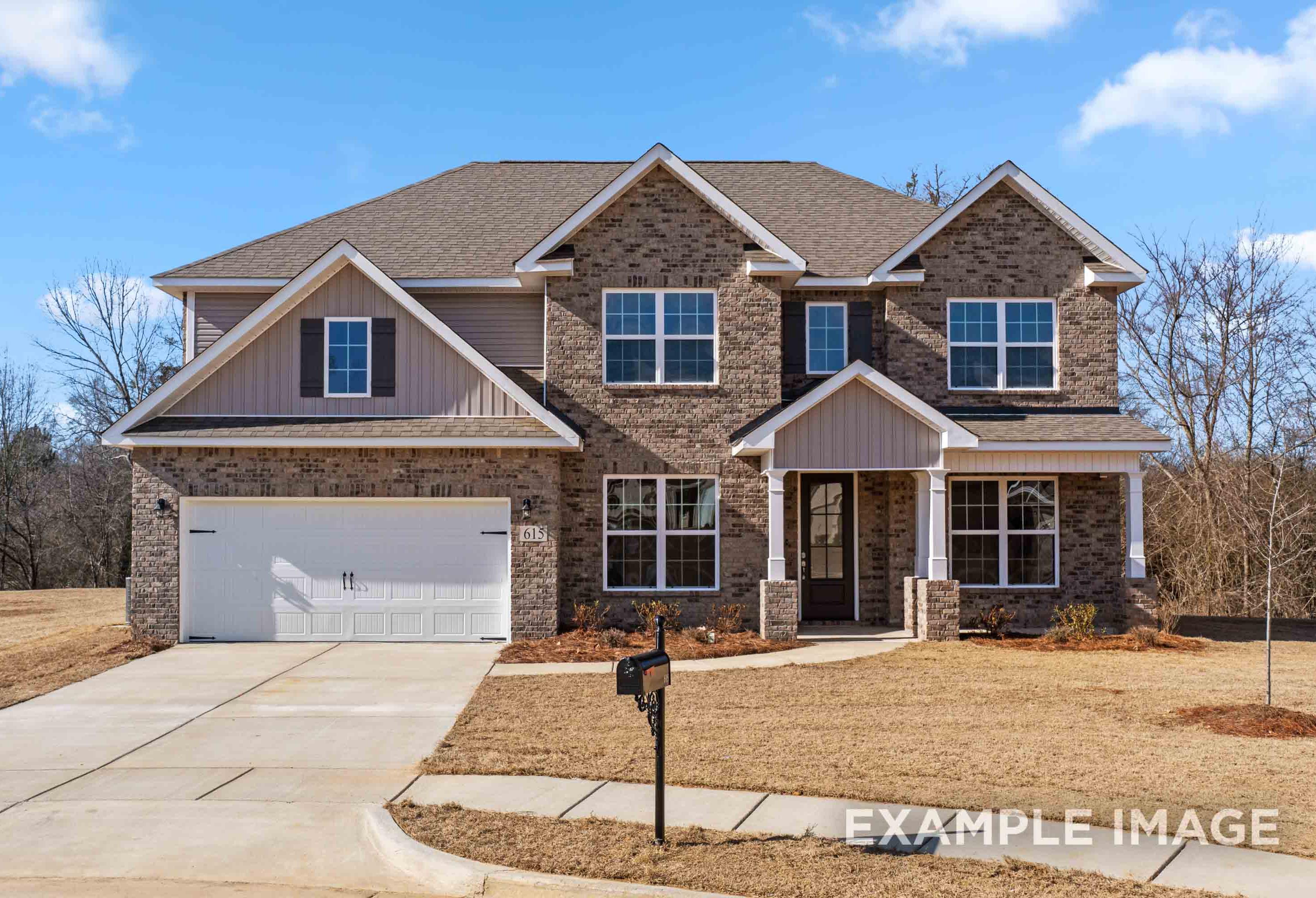 Two-story Madison B home elevation featuring brick and siding exterior, two-car garage, front porch, driveway in Meridianville
