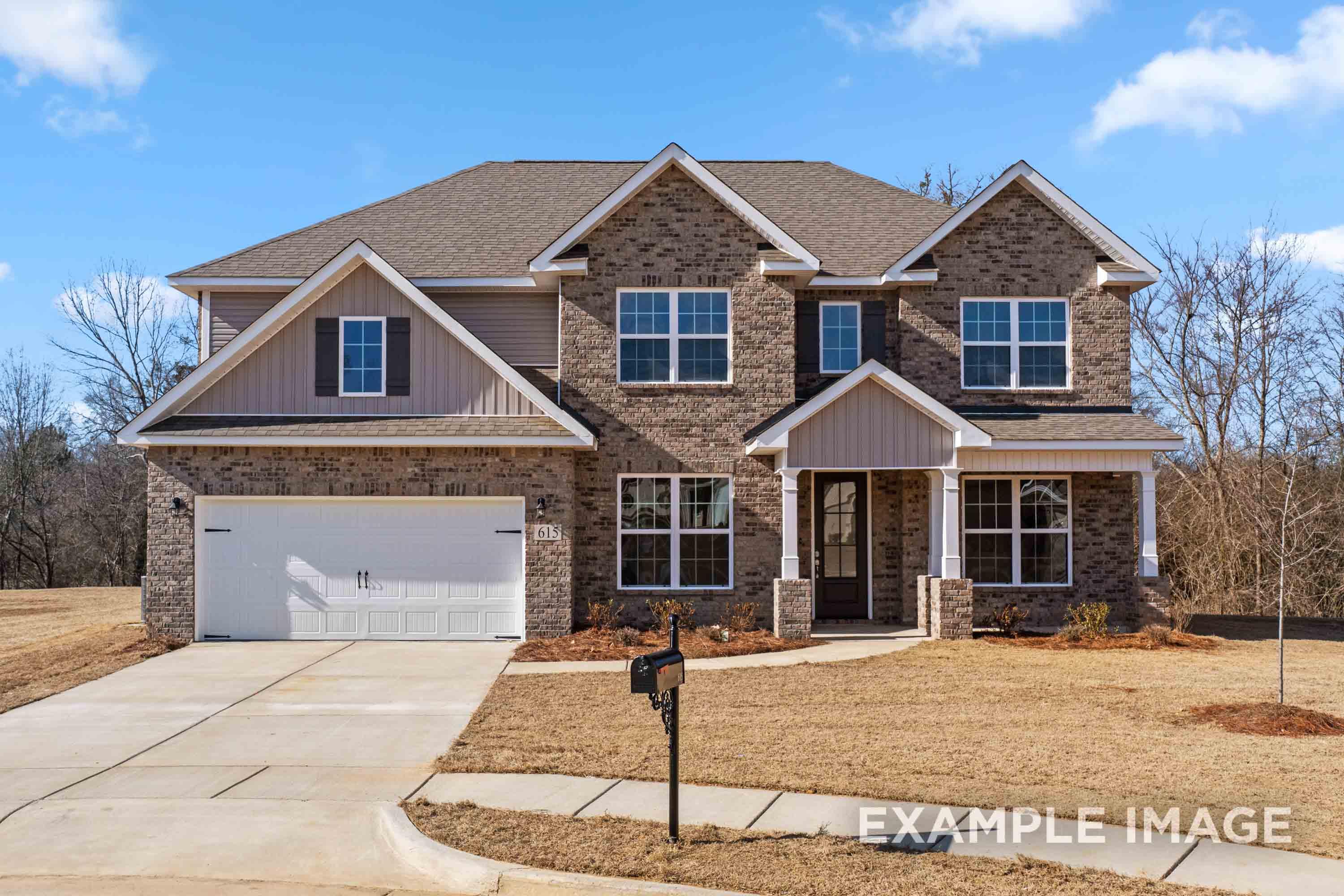 Two-story Madison B home elevation featuring brick and siding exterior, two-car garage, front porch, driveway in Meridianville