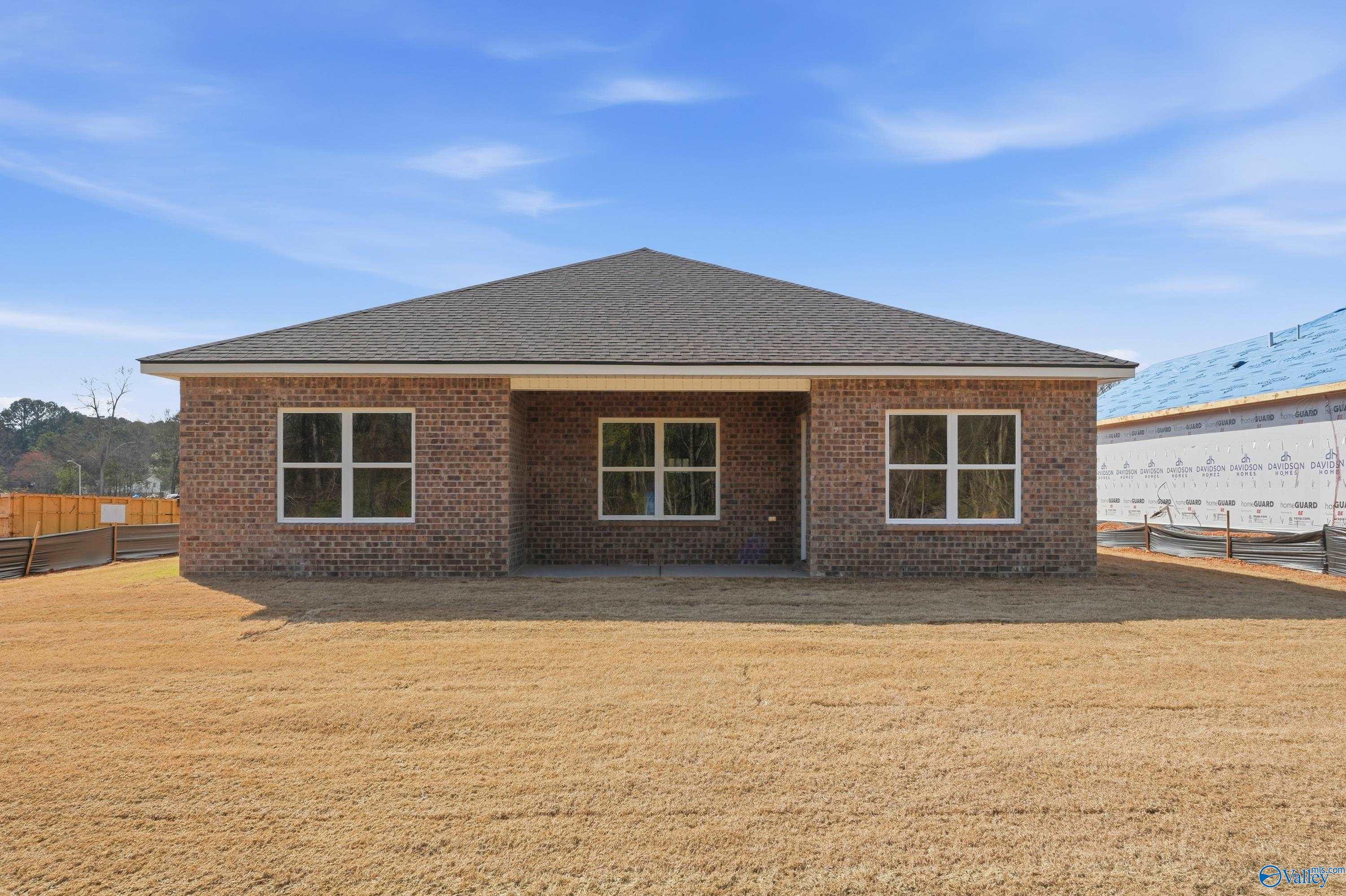 Brick ranch-style front exterior of The Asheville 3-bedroom home by Davidson Homes in Spragins Cove, Huntsville, Alabama