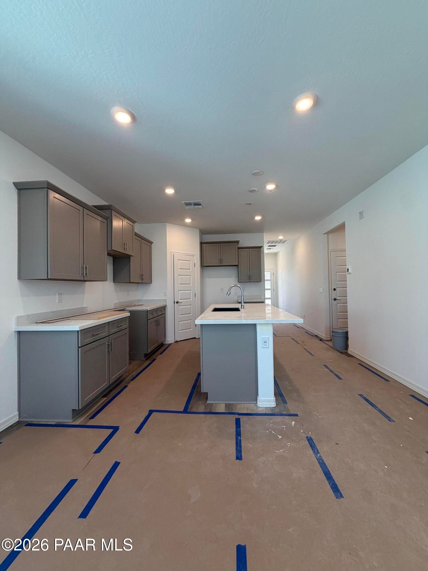 Kitchen island with gray cabinets and white quartz countertops in new Davidson Homes Marietta C floor plan, Prescott, AZ