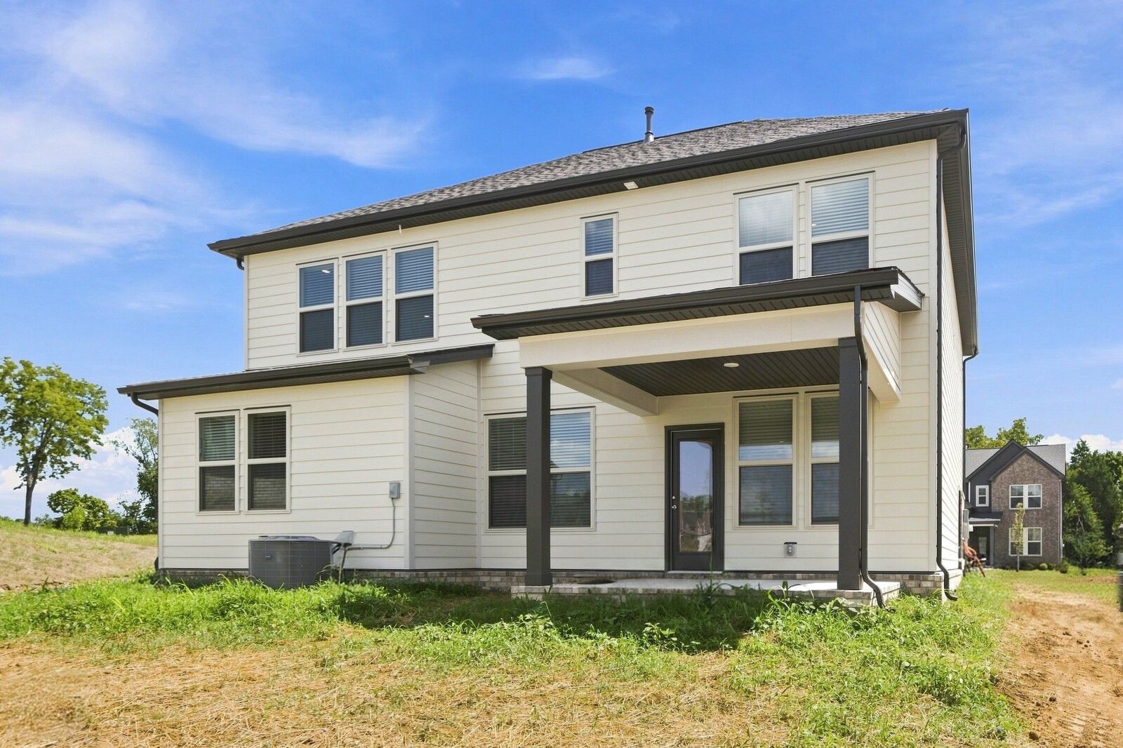 Rear exterior of 2-story Davidson Homes Willow C plan with covered patio in Woods Crossing, Gallatin, Tennessee