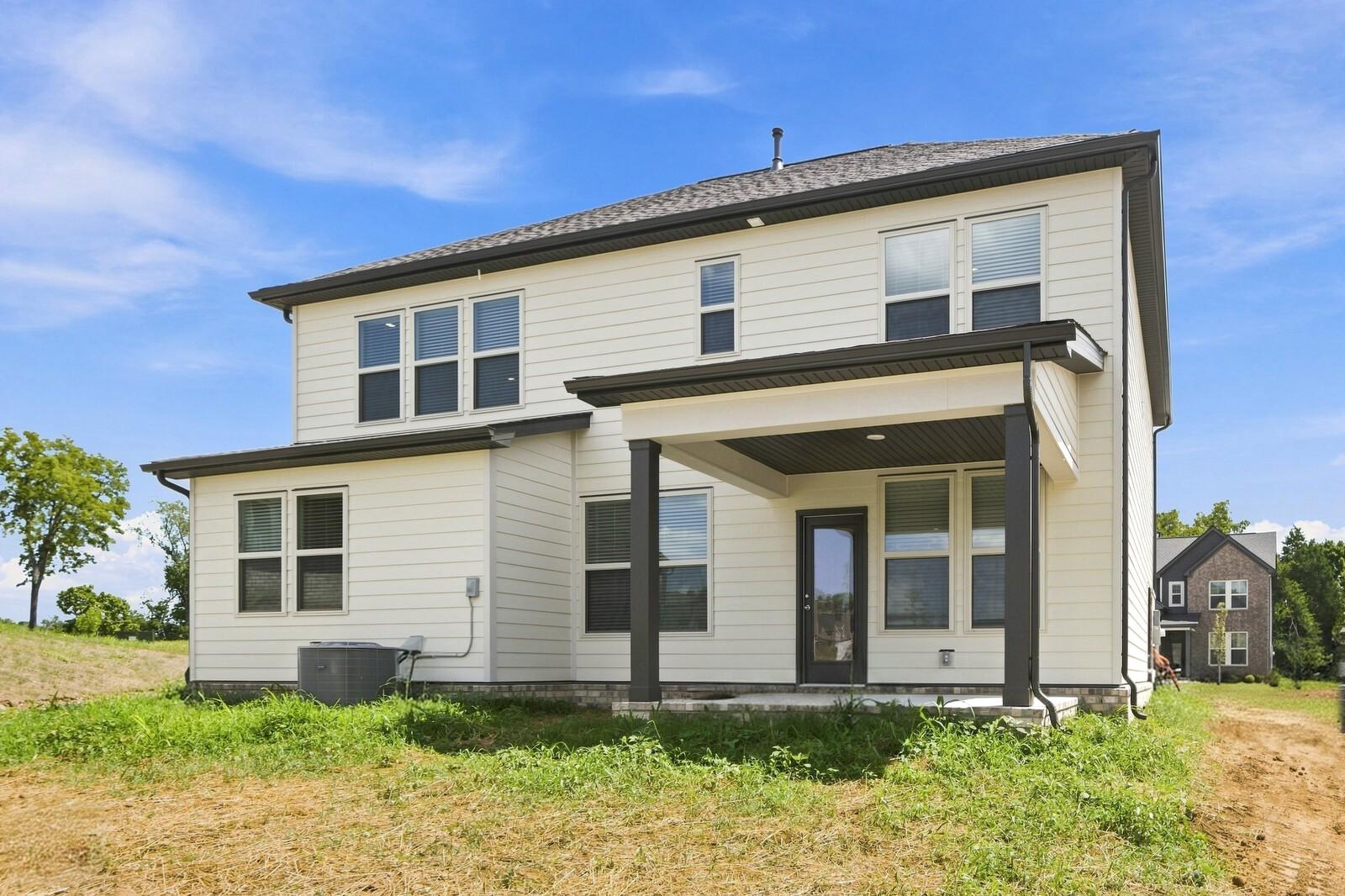 Rear exterior of 2-story Davidson Homes Willow C plan with covered patio in Woods Crossing, Gallatin, Tennessee