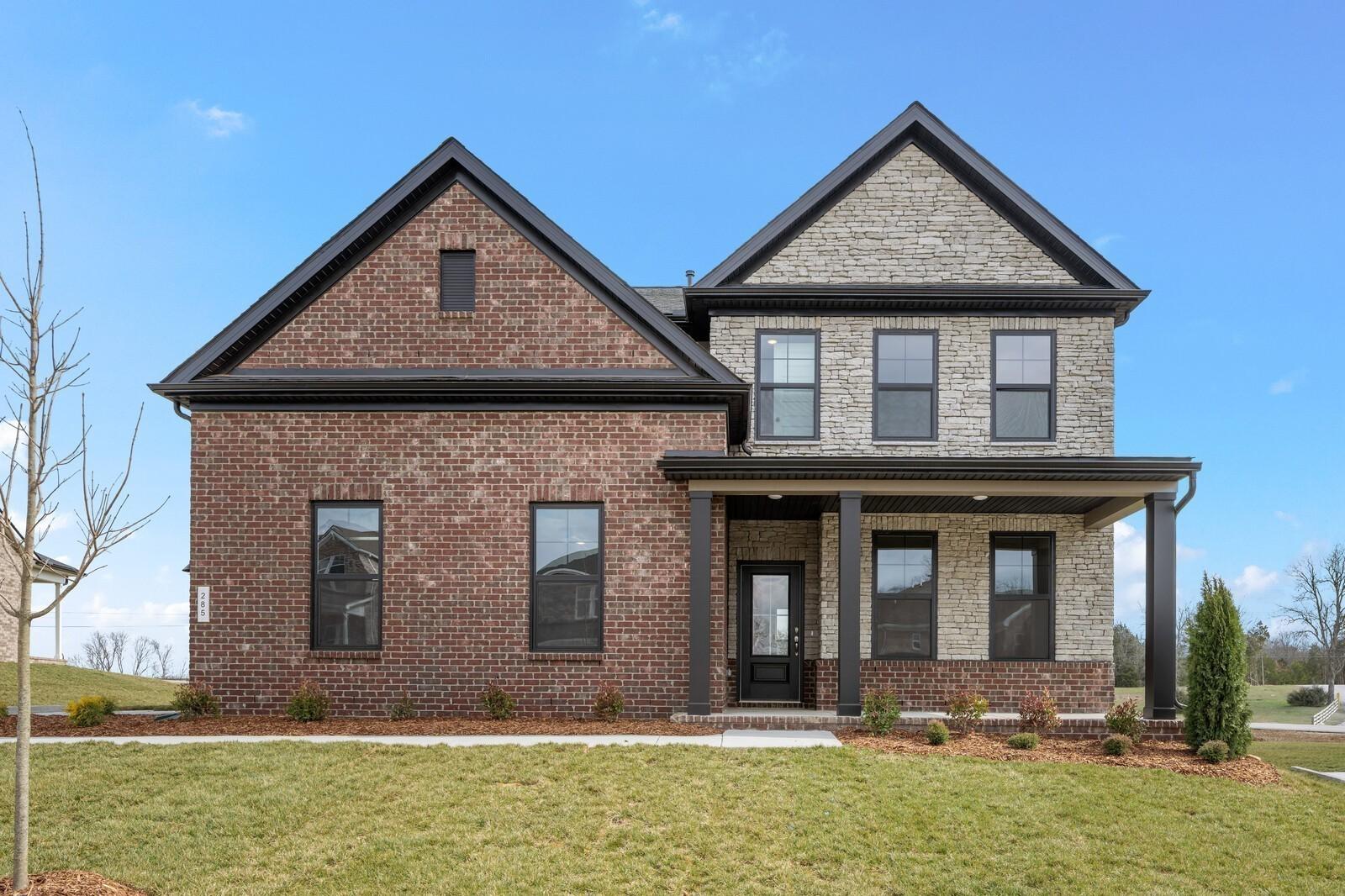 Two-story brick and stone facade of The Henry C floor plan by Davidson Homes in Benders Cove, Mt. Juliet, Tennessee.