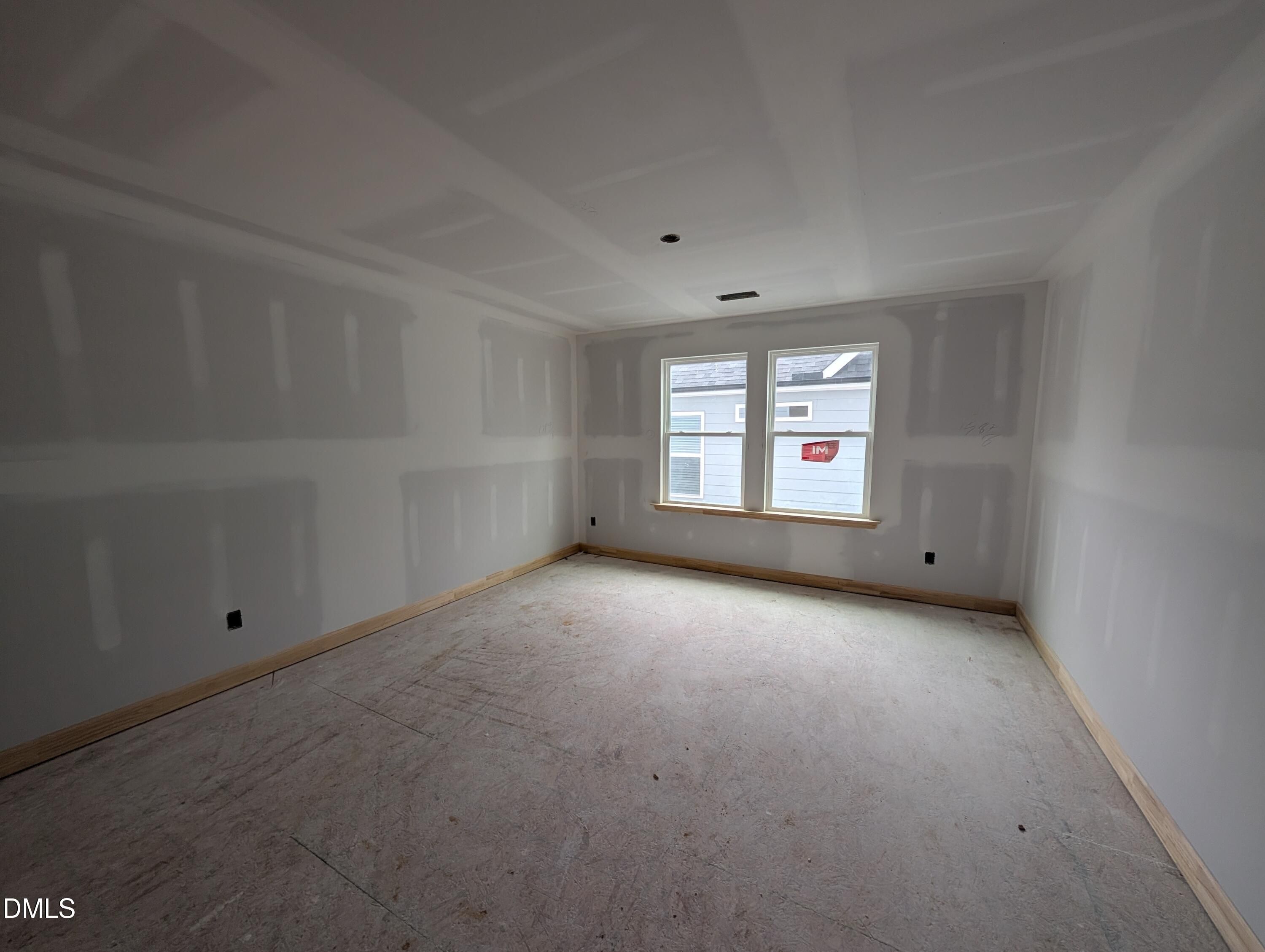 Unfinished bedroom with double windows and wood trim in Davidson Homes The Beech new construction home, Wendell Ridge, NC