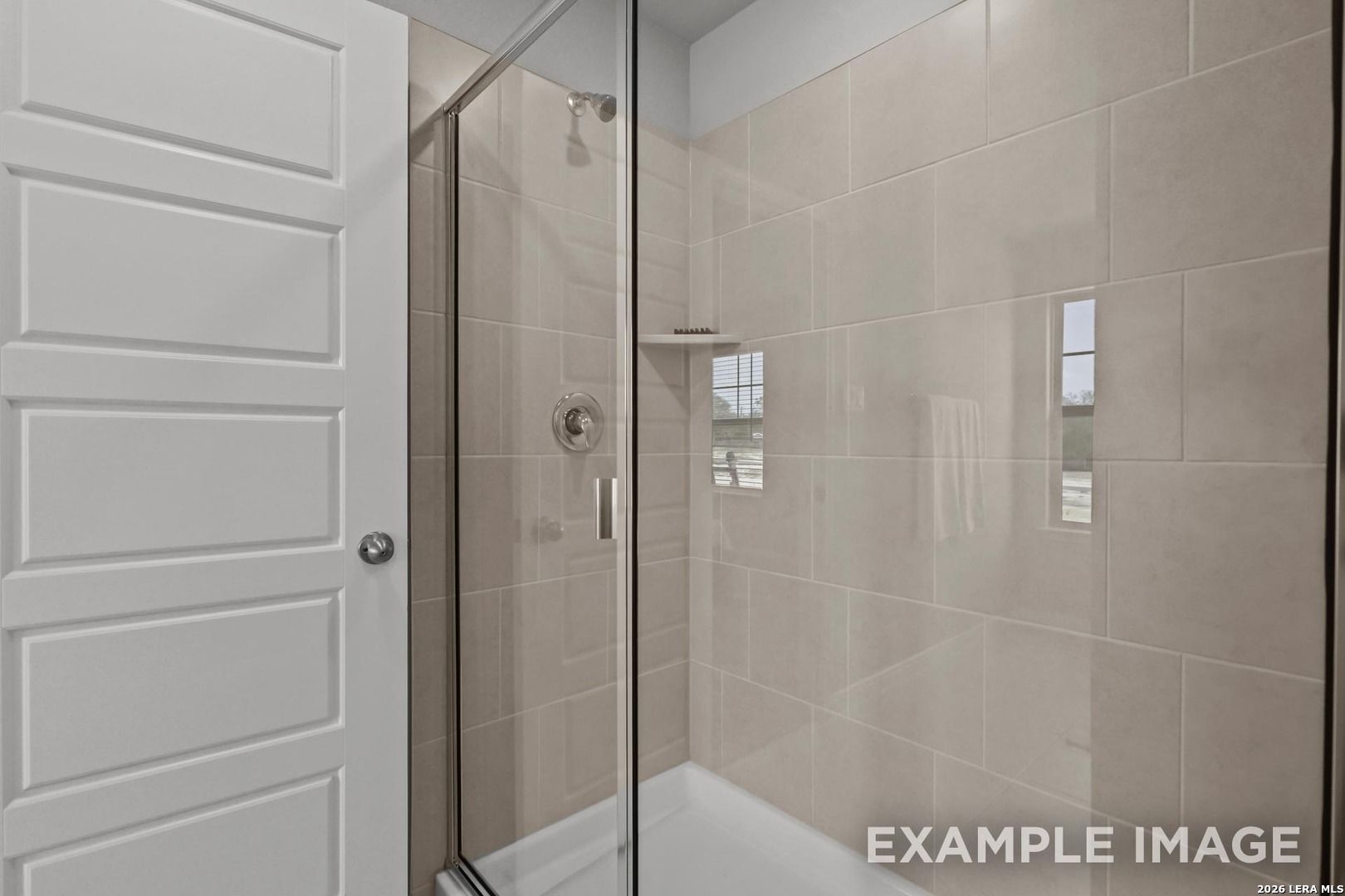 Walk-in shower with tiled walls and glass door in The Gillian A floor plan home by Davidson Homes in San Antonio, TX.