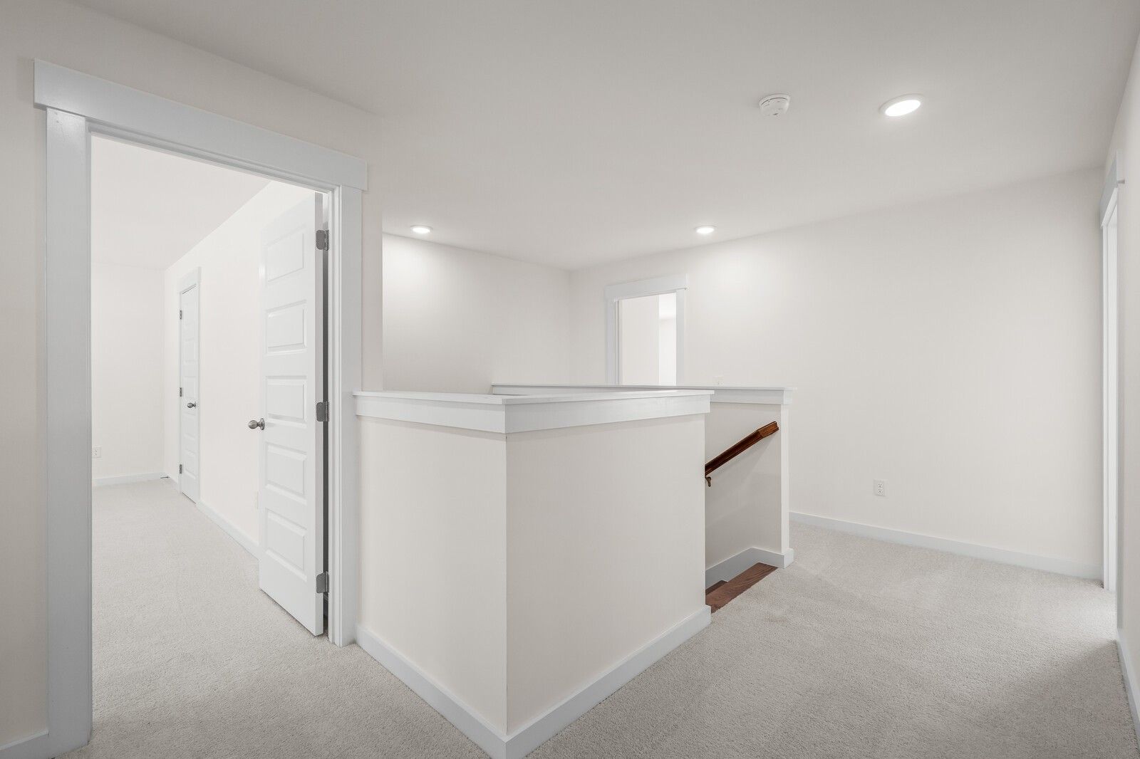 Bright, carpeted upstairs hallway and landing in The Willow floor plan at Woods Crossing, Gallatin, Tennessee.