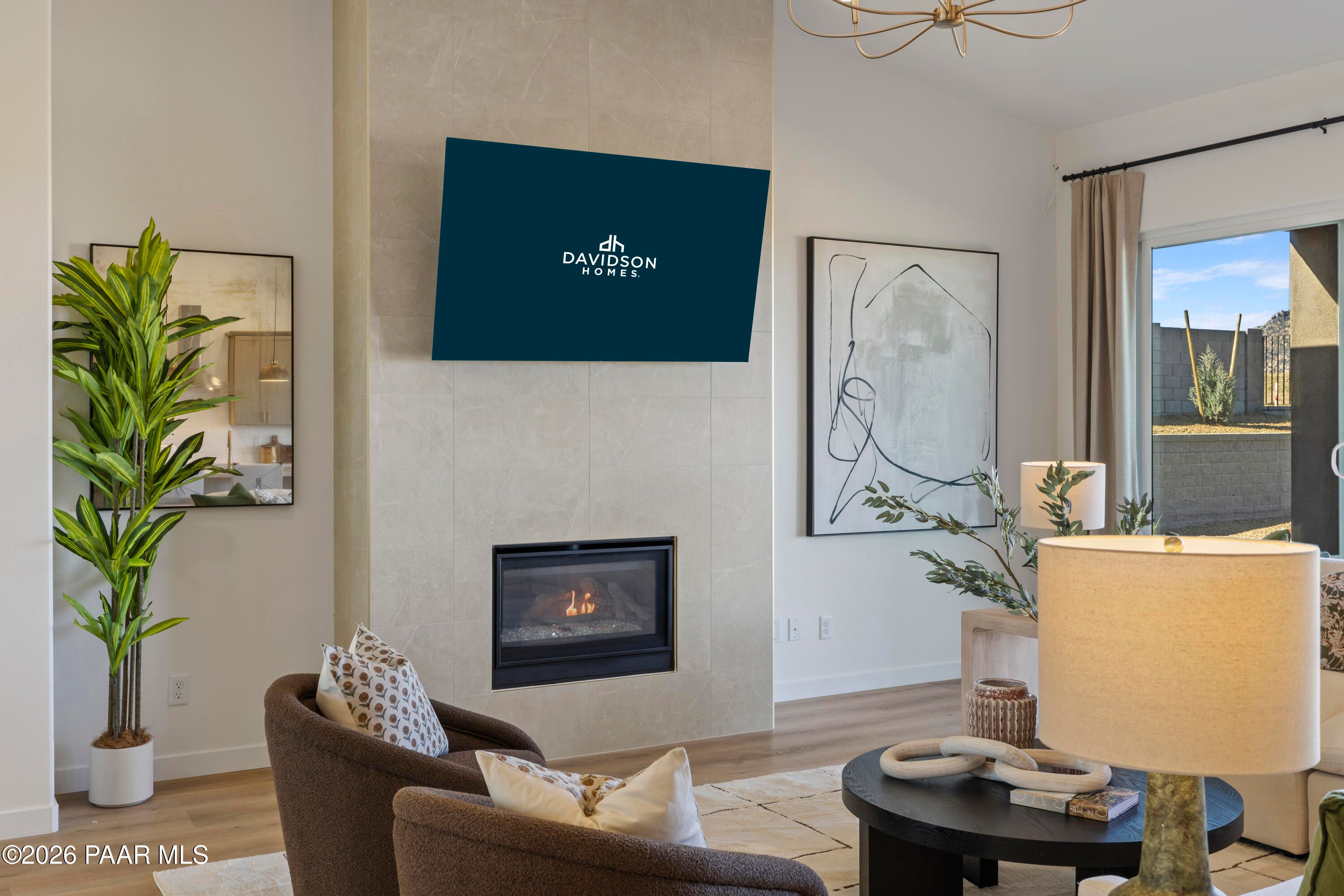 Modern living room with tile fireplace and flat-screen TV in The Blaze D floor plan by Davidson Homes, Hidden Hills, Prescott