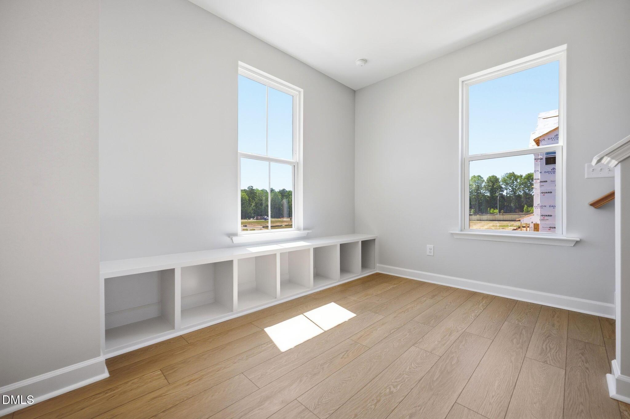 Bright room with built-in bench seating and hardwood floors in The Avery floor plan at Forestville Yard, Knightdale, NC.