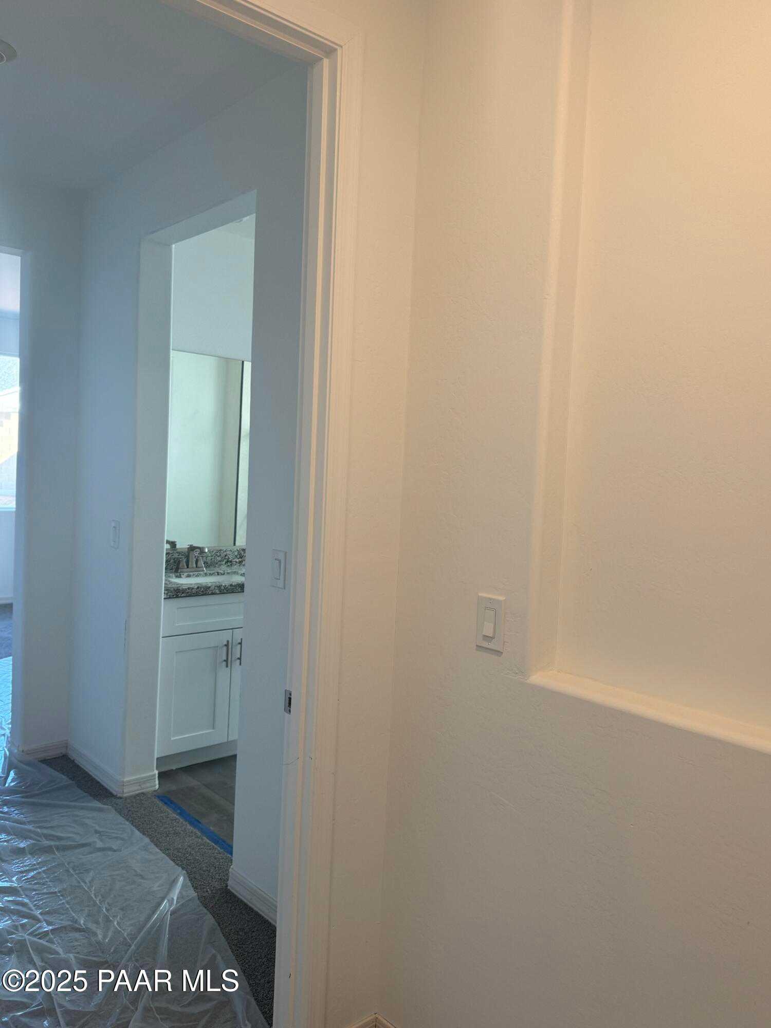 Modern bathroom vanity with double sinks, framed mirror, and white cabinets in Davidson Homes The Summit A, Prescott Arizona