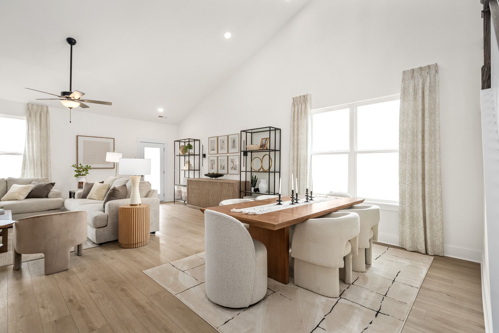 Spacious open-concept living and dining in The Ridgeport E by Davidson Homes, with neutral tones, vaulted ceiling, and modern furnishings