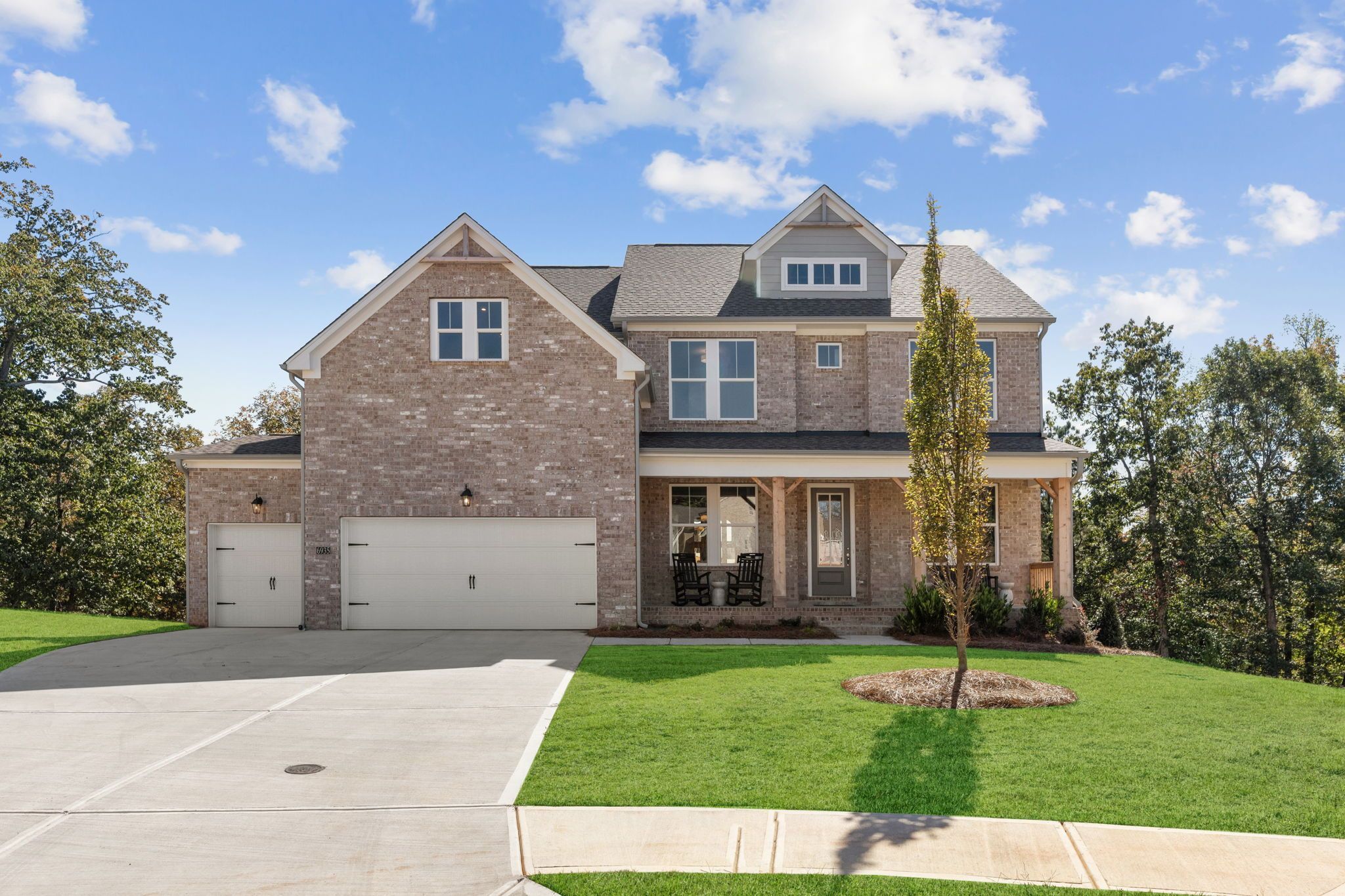 Brick exterior of a Davidson Homes house at Melody Lakeside Estates in Buford, Georgia with a covered front porch.