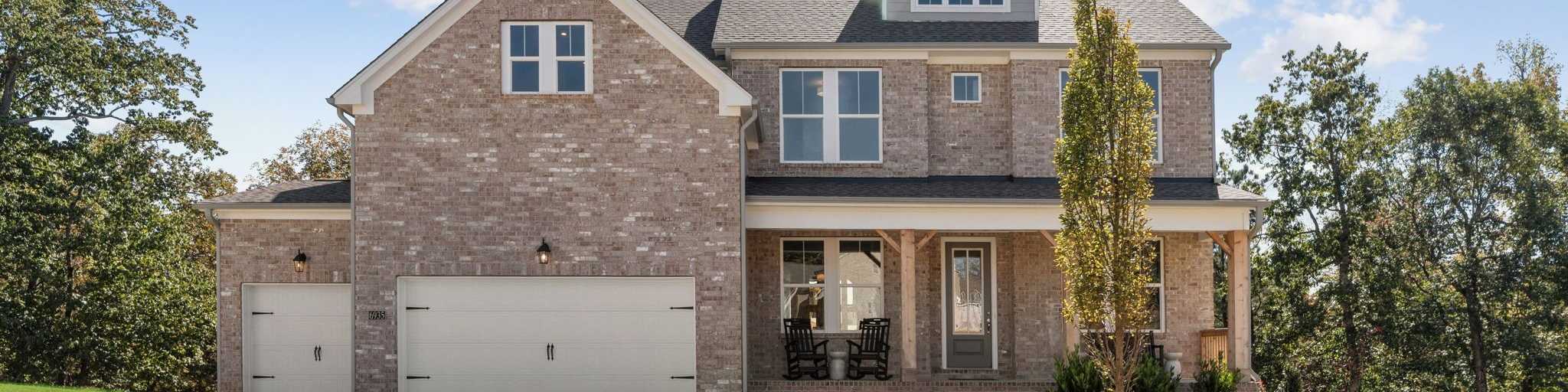 Brick exterior of a Davidson Homes house at Melody Lakeside Estates in Buford, Georgia with a covered front porch.