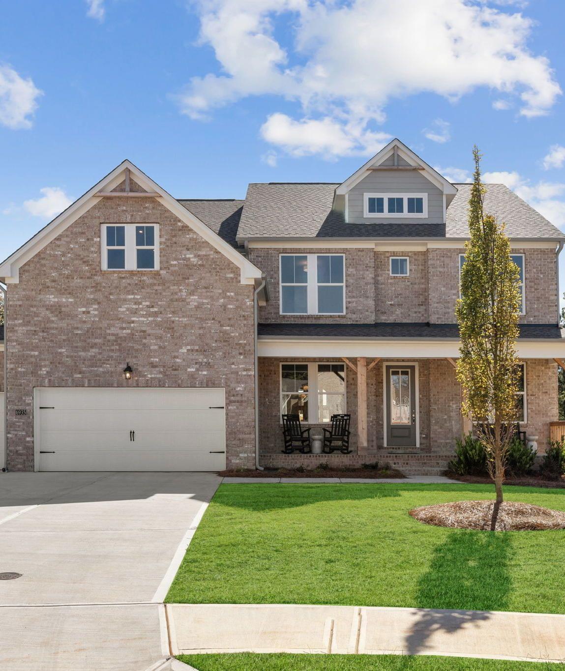 Brick exterior of a Davidson Homes house at Melody Lakeside Estates in Buford, Georgia with a covered front porch.