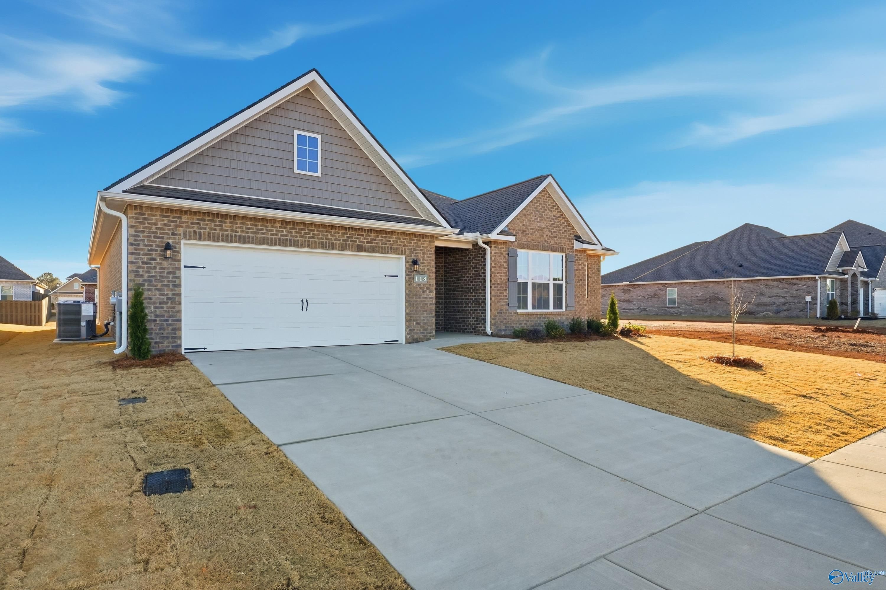 Brick 1-story home with 2-car garage, driveway, and landscaping in Kendall Downs, Toney, Alabama - Davidson Homes Montgomery B