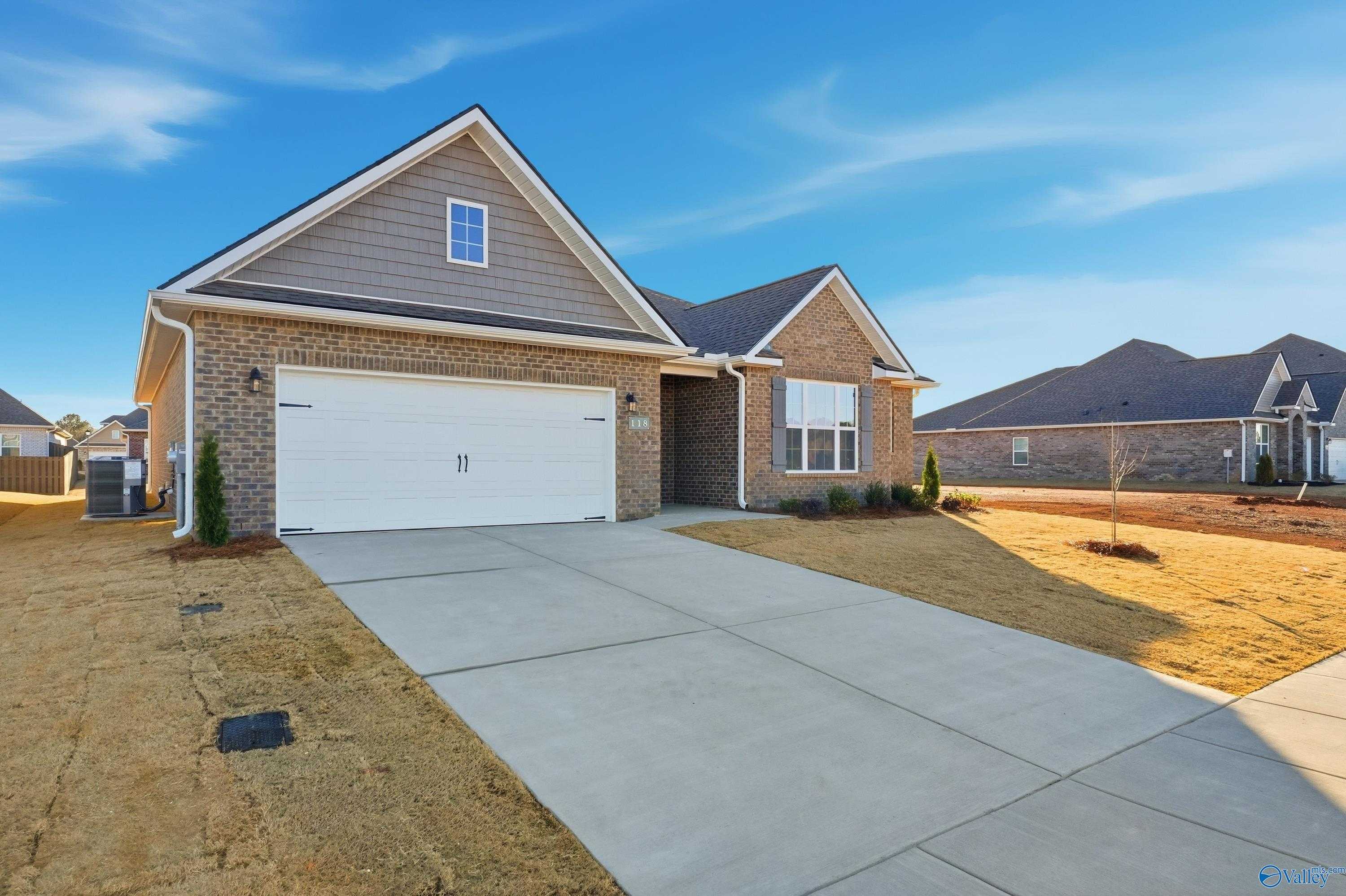 Brick 1-story home with 2-car garage, driveway, and landscaping in Kendall Downs, Toney, Alabama - Davidson Homes Montgomery B