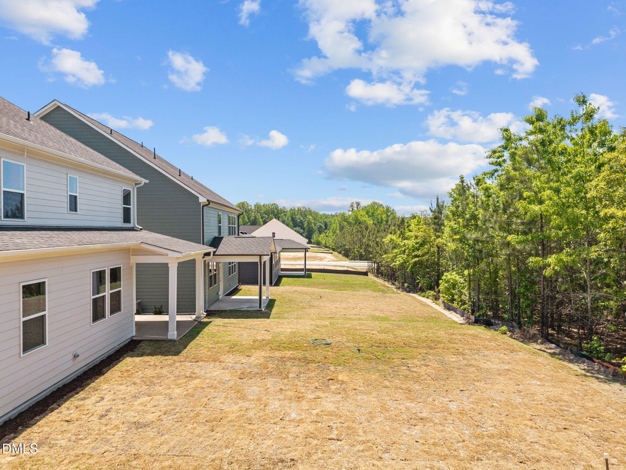 Two-story 4-bedroom homes with covered porches and garages in wooded Wendell Ridge community, Davidson Homes Willow D, Wendell NC