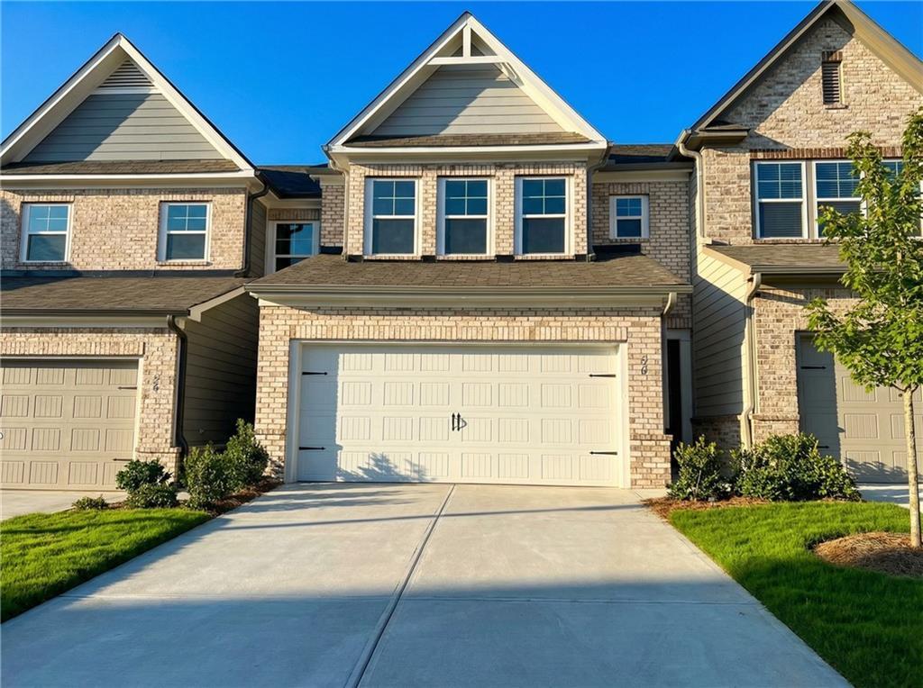 Modern two-story brick home with 2-car garage, driveway, and landscaping in Lake Shore, Winder, Georgia - Davidson Homes The Marion A