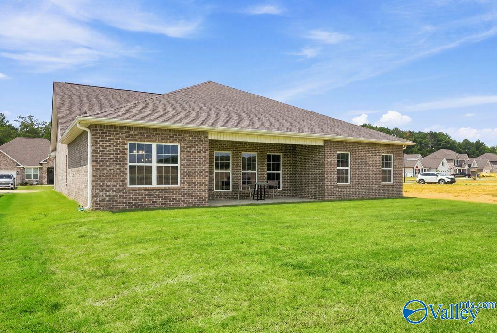 Brick exterior of Davidson Homes The Harrison with covered patio and spacious backyard in Cain Park, Hartselle, Alabama