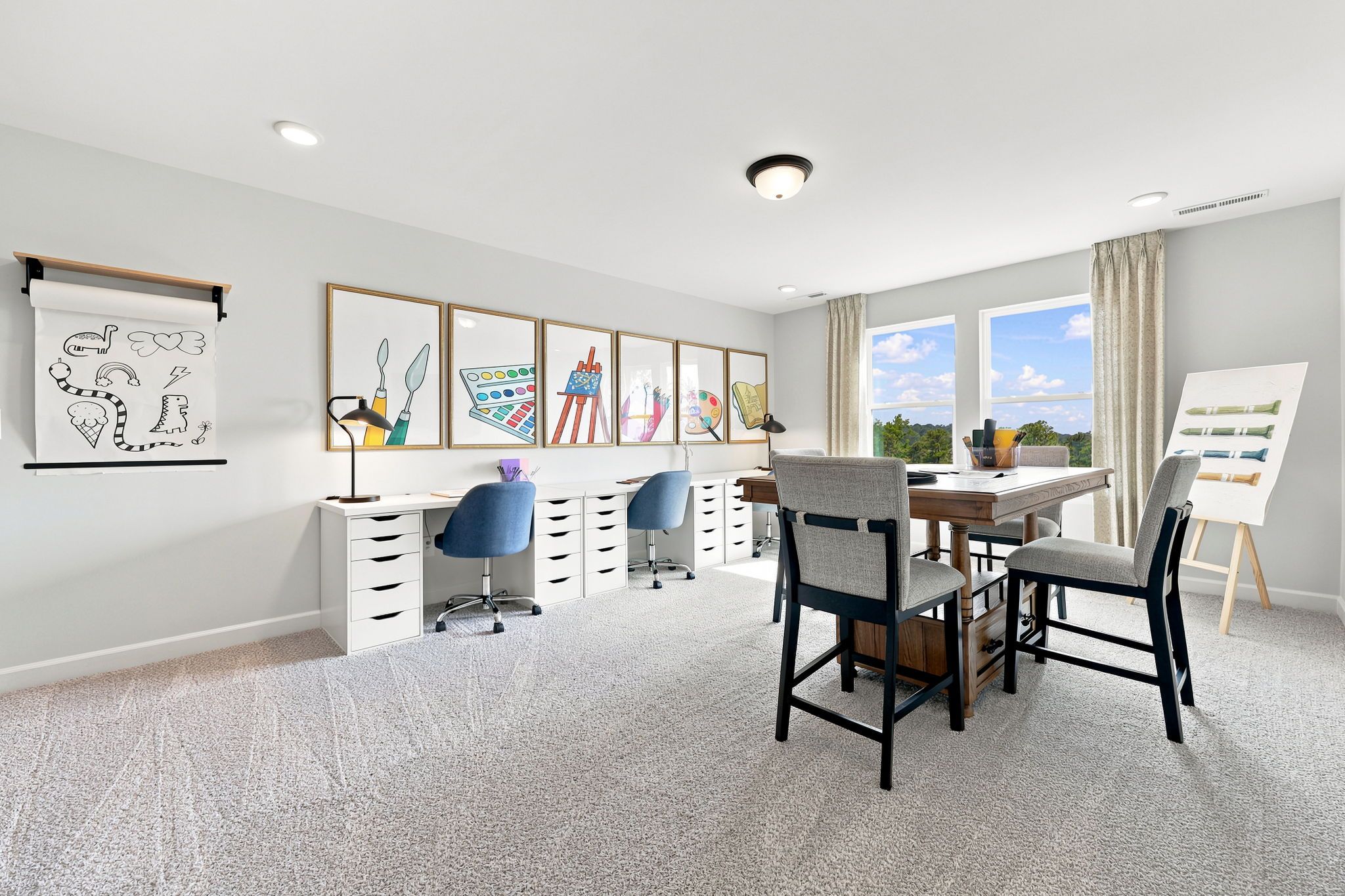 Creative hobby room at Montrose in Aberdeen, NC by Davidson Homes with a double desk, craft table, and art decor.