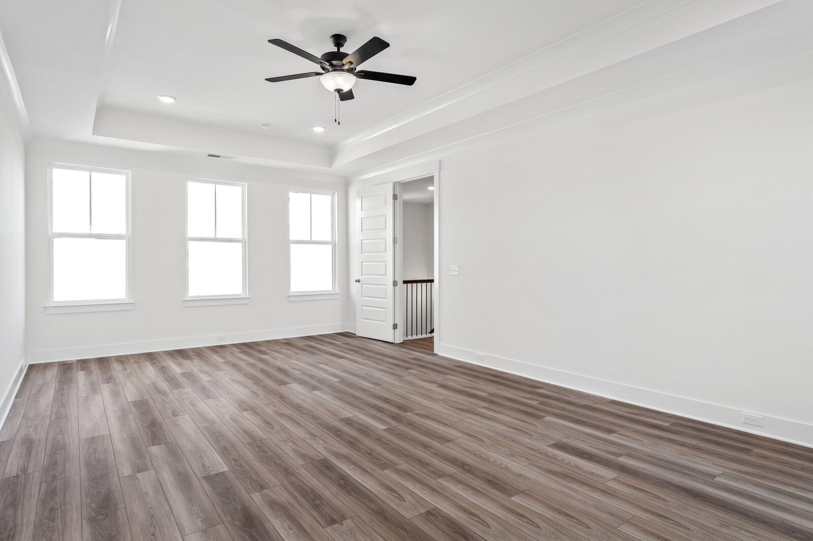 Spacious empty bonus room with hardwood floors, large windows, ceiling fan in The Alston A by Davidson Homes, Murfreesboro