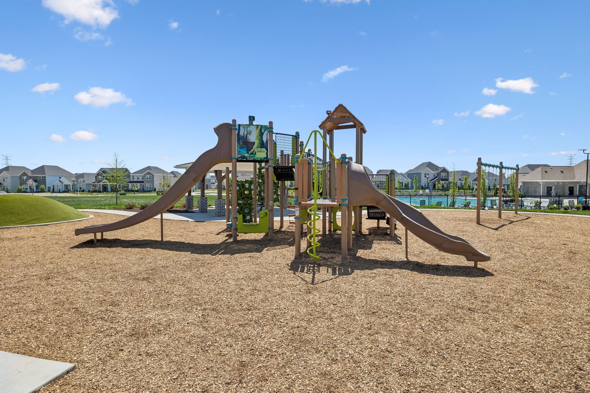 Community playground with slides and climbing structure at Bradshaw Farms in Mt. Juliet, TN by Davidson Homes.