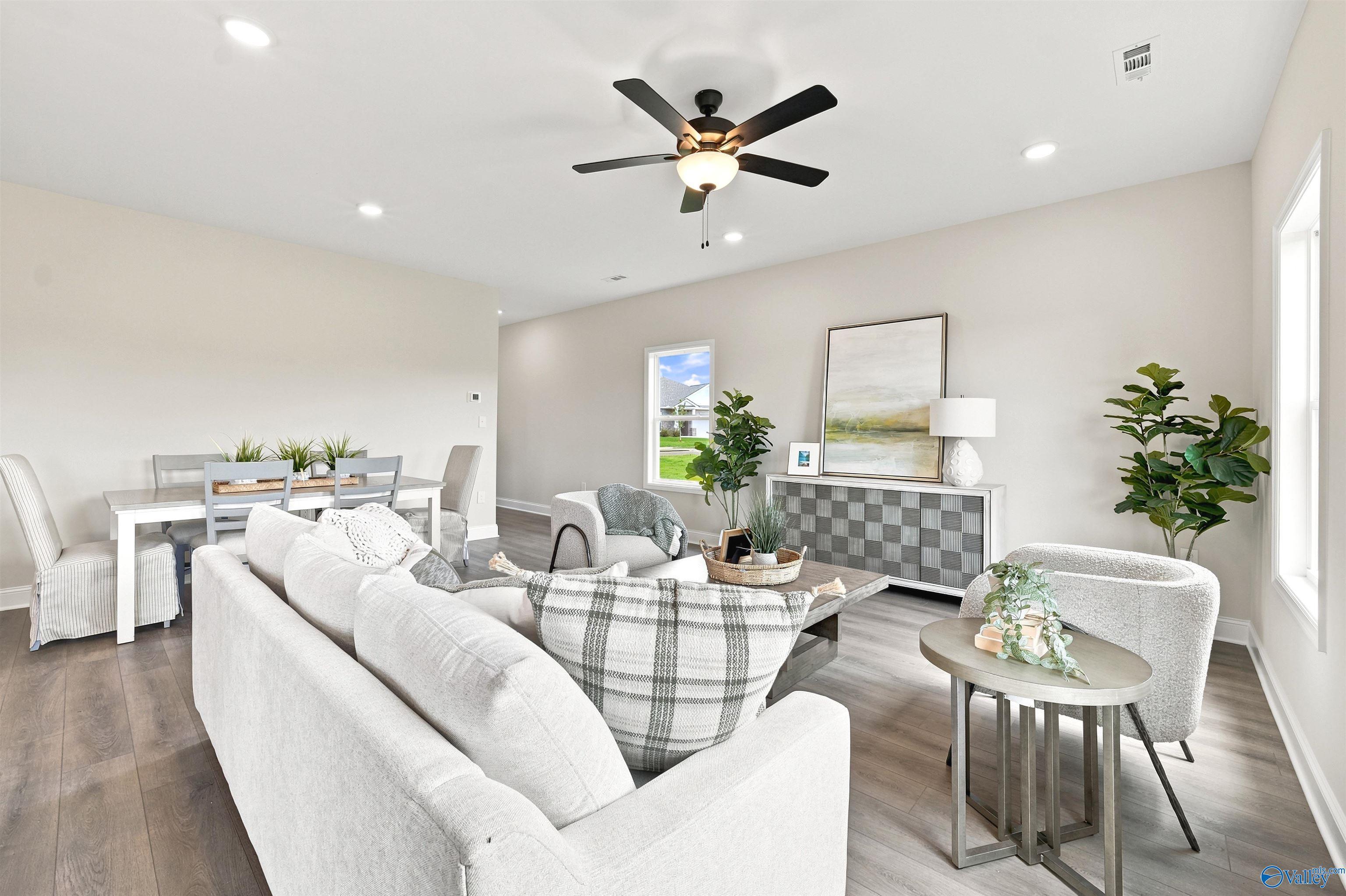 Bright, open-concept living and dining area in The Burton B floor plan at Heritage Lakes, New Market, Alabama.