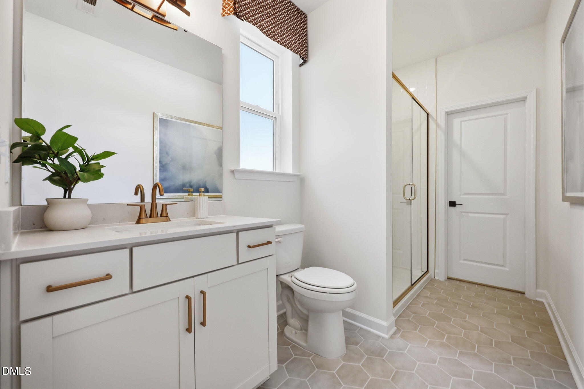 Modern bathroom with vanity, gold fixtures, and glass shower in The Aspen B floor plan at Wendell Ridge, North Carolina.