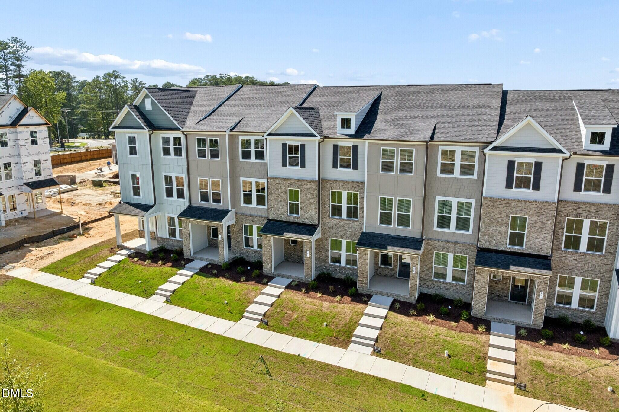 Aerial view of Davidson Homes townhome exteriors with brick facades and covered porches at Forestville Yard, Knightdale, North Carolina