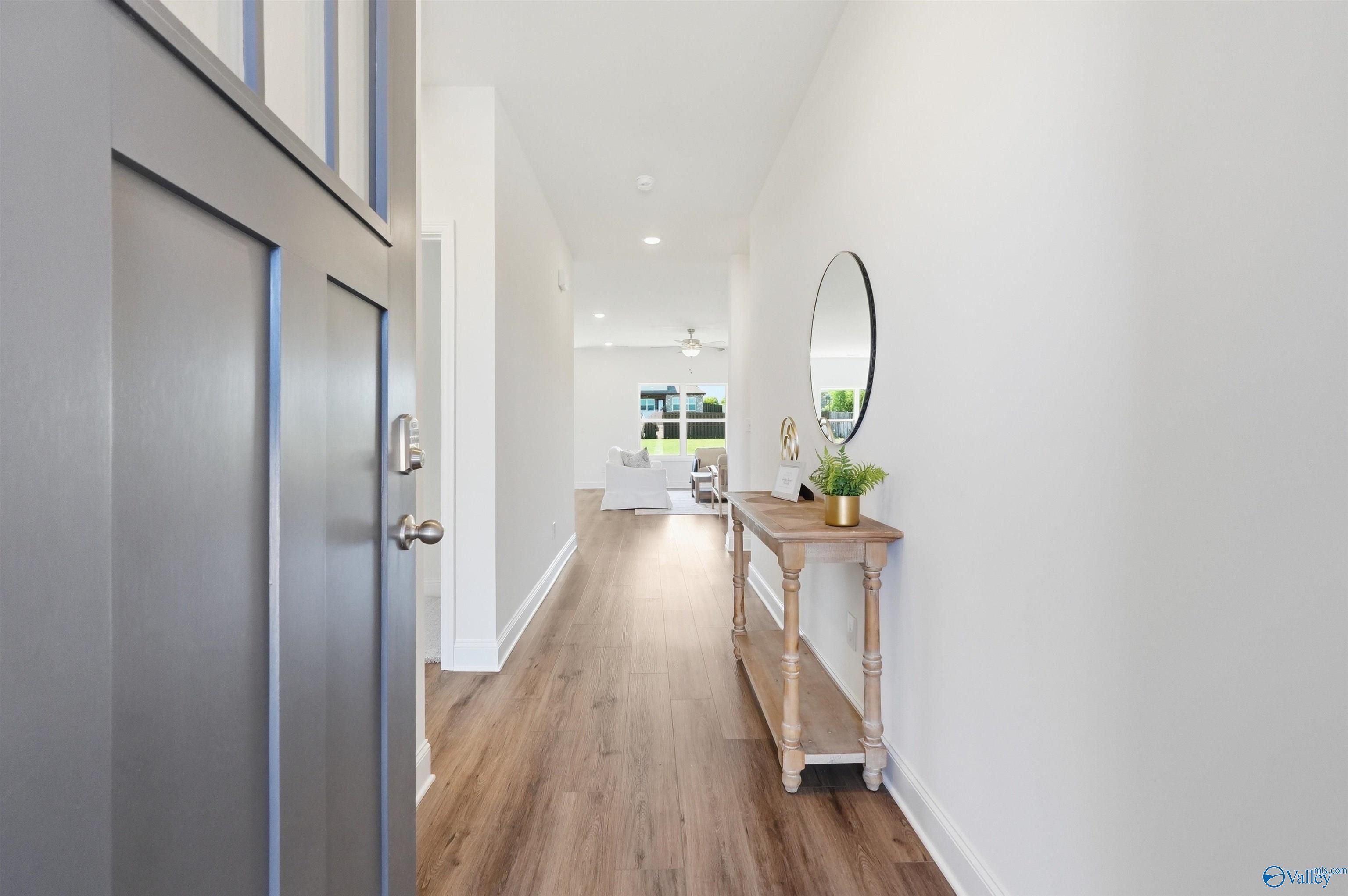 Bright entryway with wood-look flooring leading to open floor plan in The Franklin C home, Lynn Meadows, Meridianville, AL.