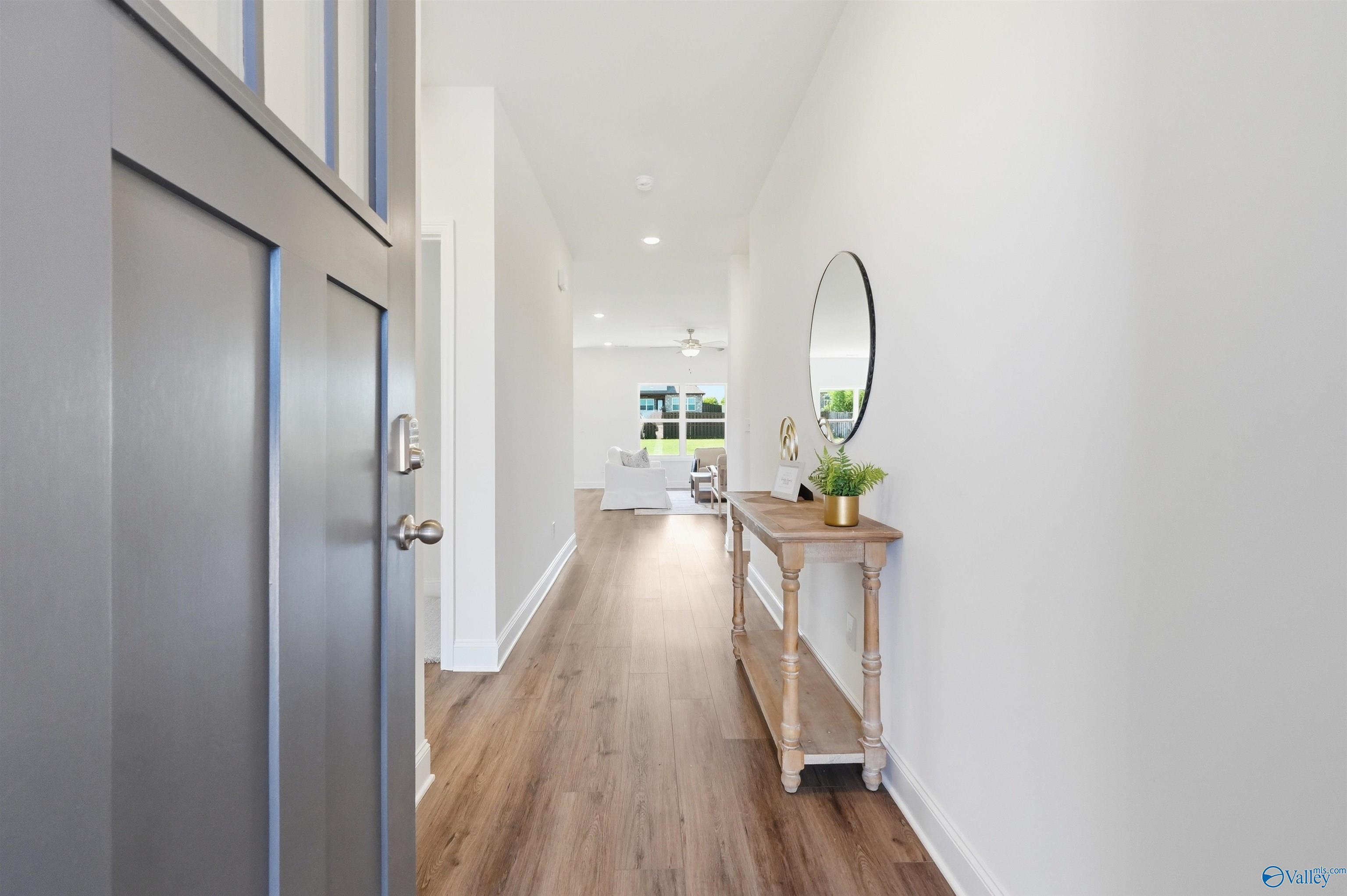 Bright entryway with wood-look flooring leading to open floor plan in The Franklin C home, Lynn Meadows, Meridianville, AL.