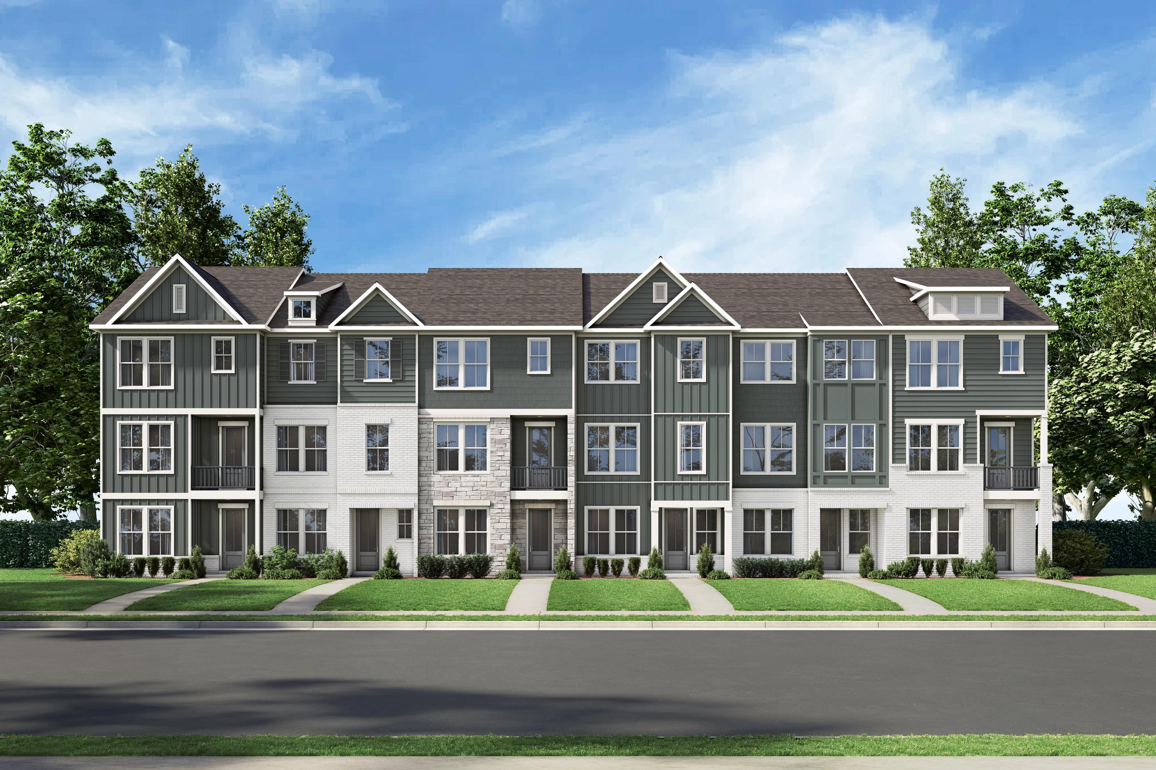 Row of modern gray townhomes at Grafton Trace in Woodstock, Georgia with pitched roofs, large windows and green lawns