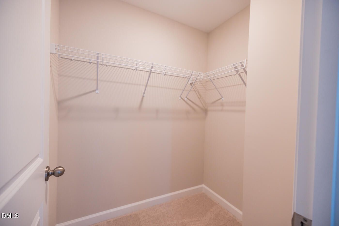 Spacious walk-in closet with wire shelving and hanging rods in master suite of The Hickory II C, Woodland Crossing, Zebulon, NC