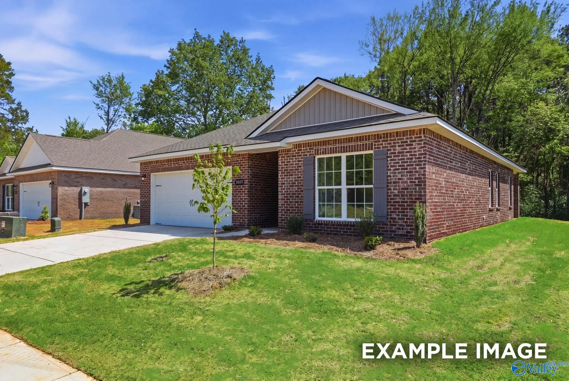 Brick exterior of The Franklin C floor plan by Davidson Homes with a 2-car garage in The Highlands, Arab, Alabama.