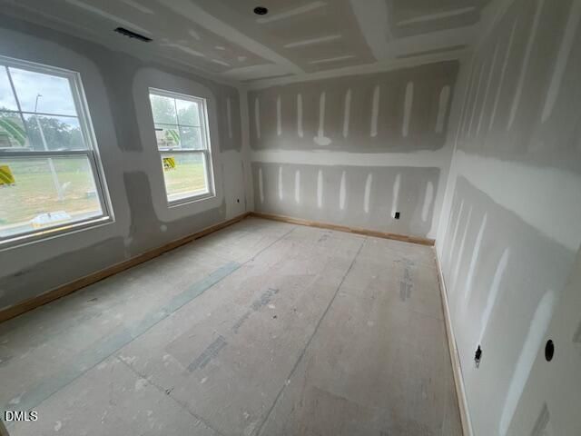 Unfinished bedroom with drywall and subflooring in The Hickory II C floor plan at Retreat at North Main, Lillington, NC.