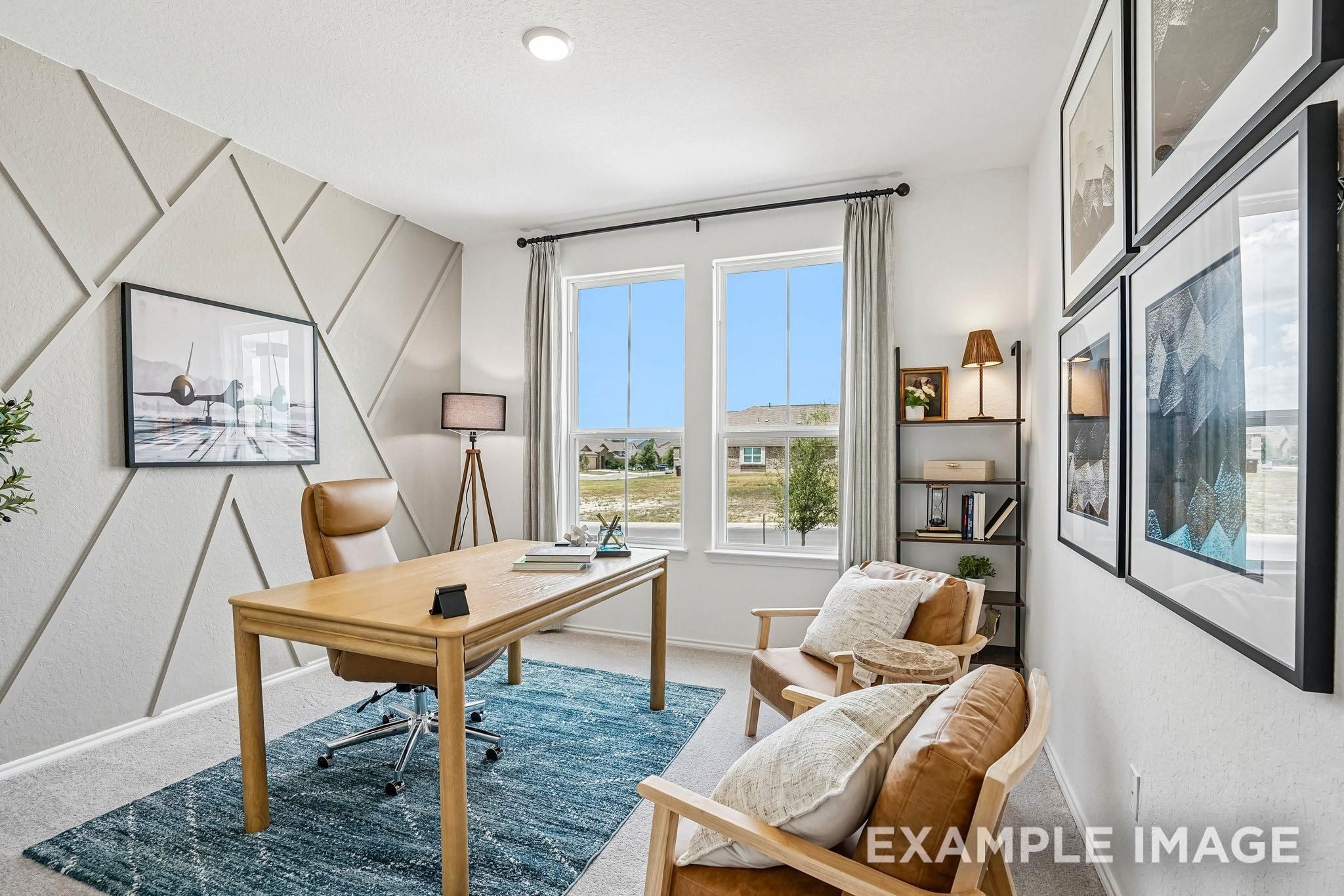 Bright home office with geometric accent wall, wooden desk, leather chairs, and large windows in Davidson Homes Ashport J, Crosby TX