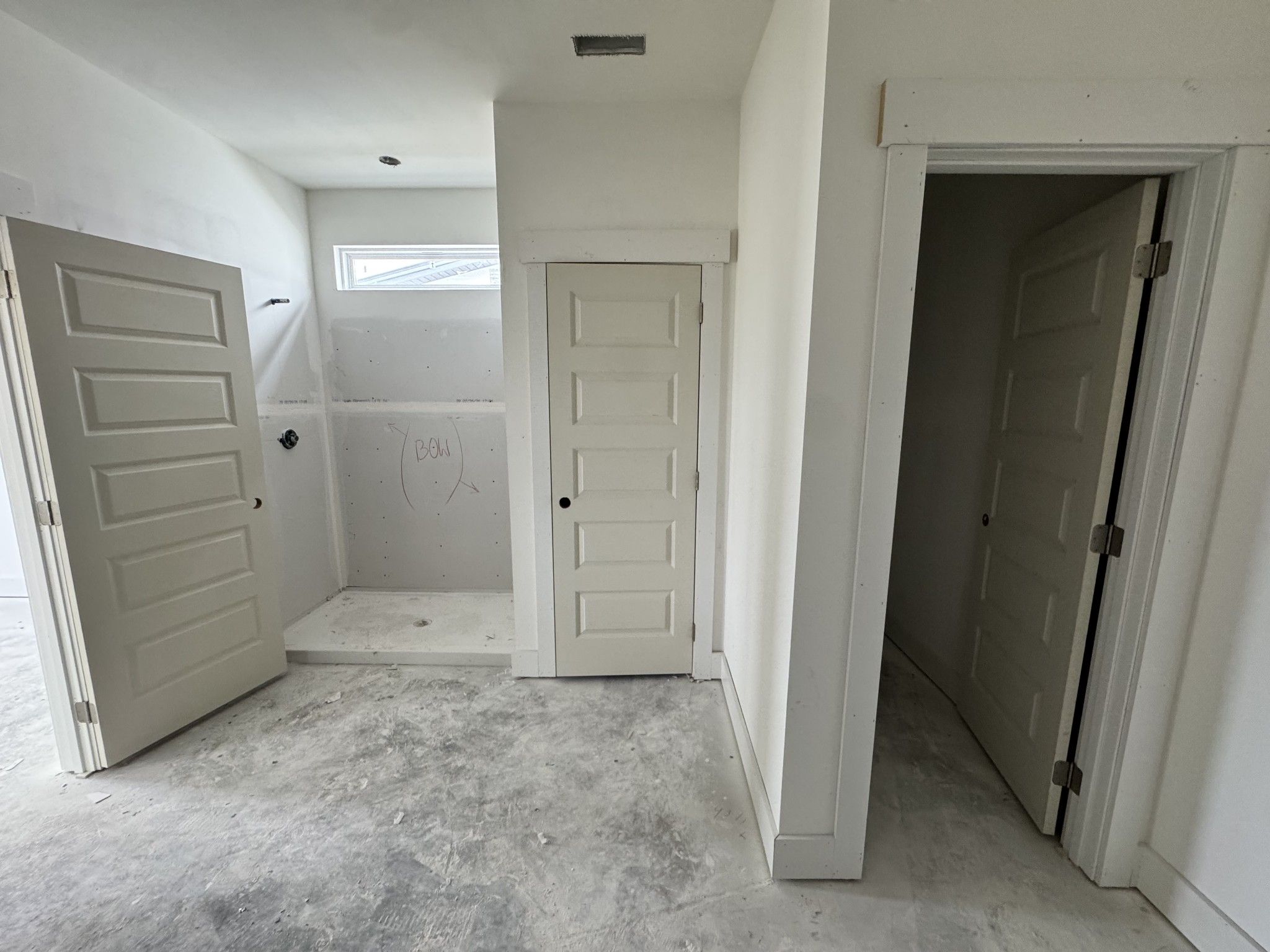 Spacious master bathroom with frameless glass shower enclosure and walk-in closet access in Davidson Homes The Cottonwood E, Gallatin, TN