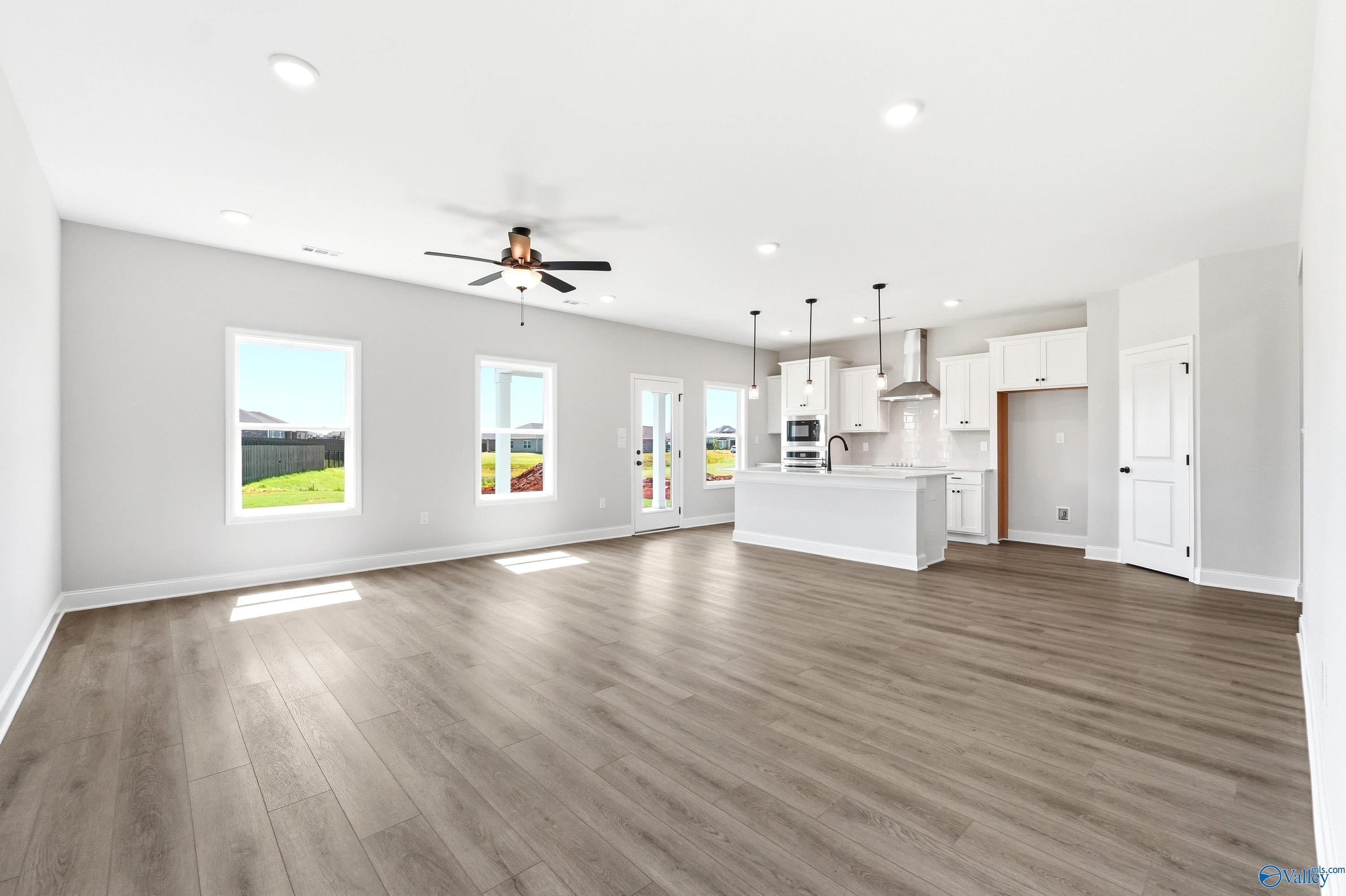 Open-concept living room and kitchen in The Burton B floor plan by Davidson Homes in Heritage Lakes, New Market, Alabama.