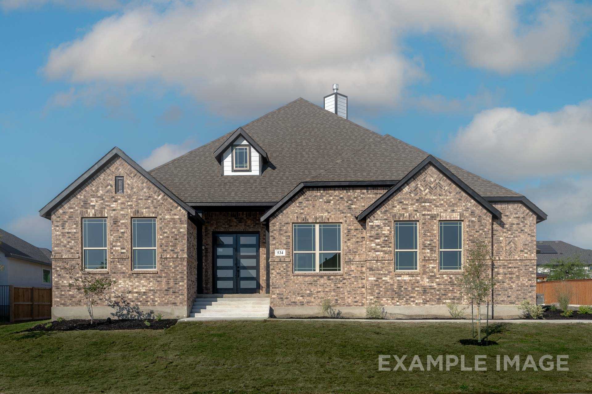 Brick exterior elevation of The Summerlin A single-story home by Davidson Homes in Castroville Texas featuring gabled roof and double doors