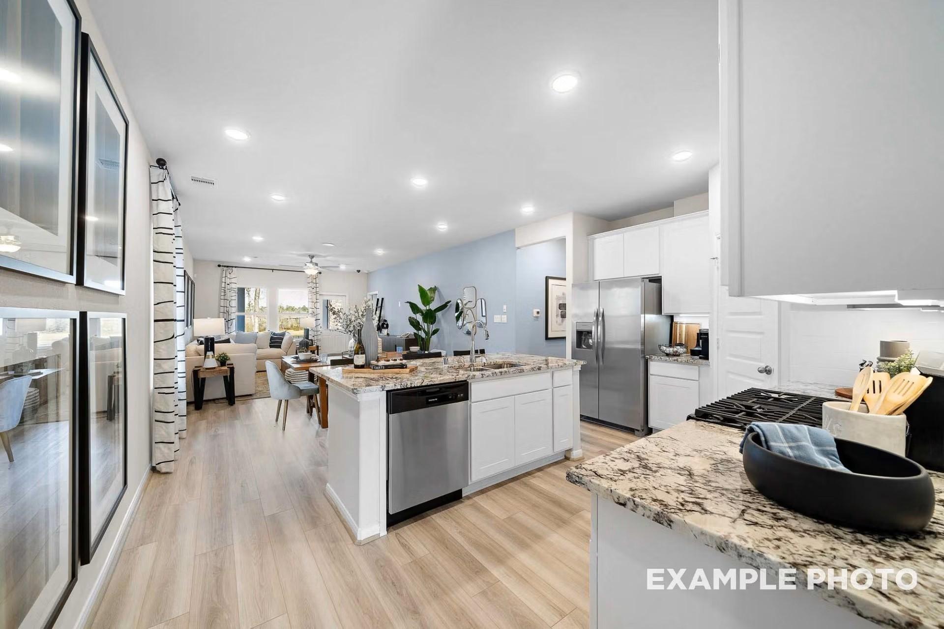 Open-concept kitchen and living area in The San Marcos E floor plan by Davidson Homes in Heartland, Texas.