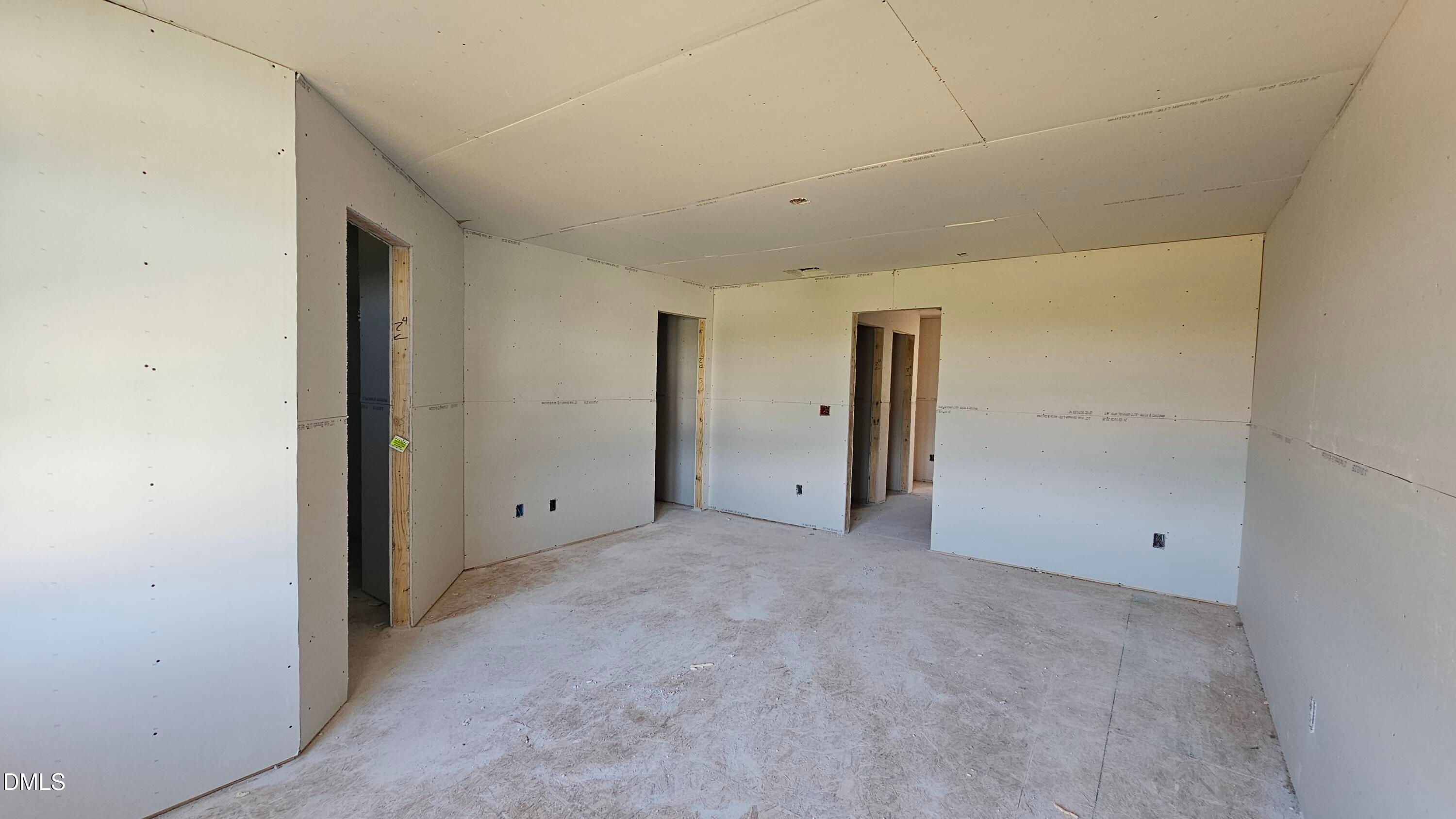 Unfinished interior room with drywall installation in The Graham floor plan by Davidson Homes in Springvale, Fuquay-Varina.
