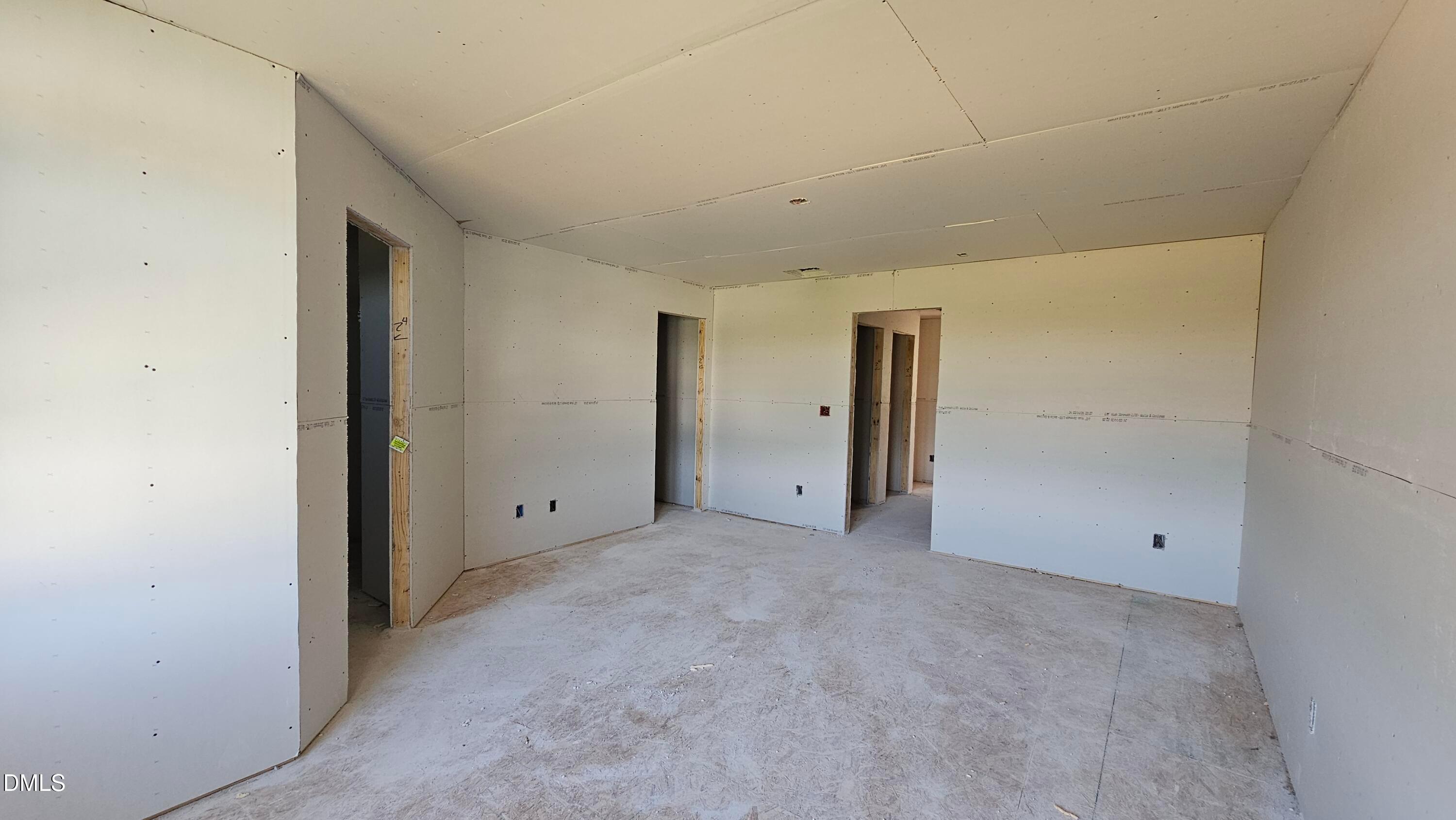 Unfinished interior room with drywall installation in The Graham floor plan by Davidson Homes in Springvale, Fuquay-Varina.