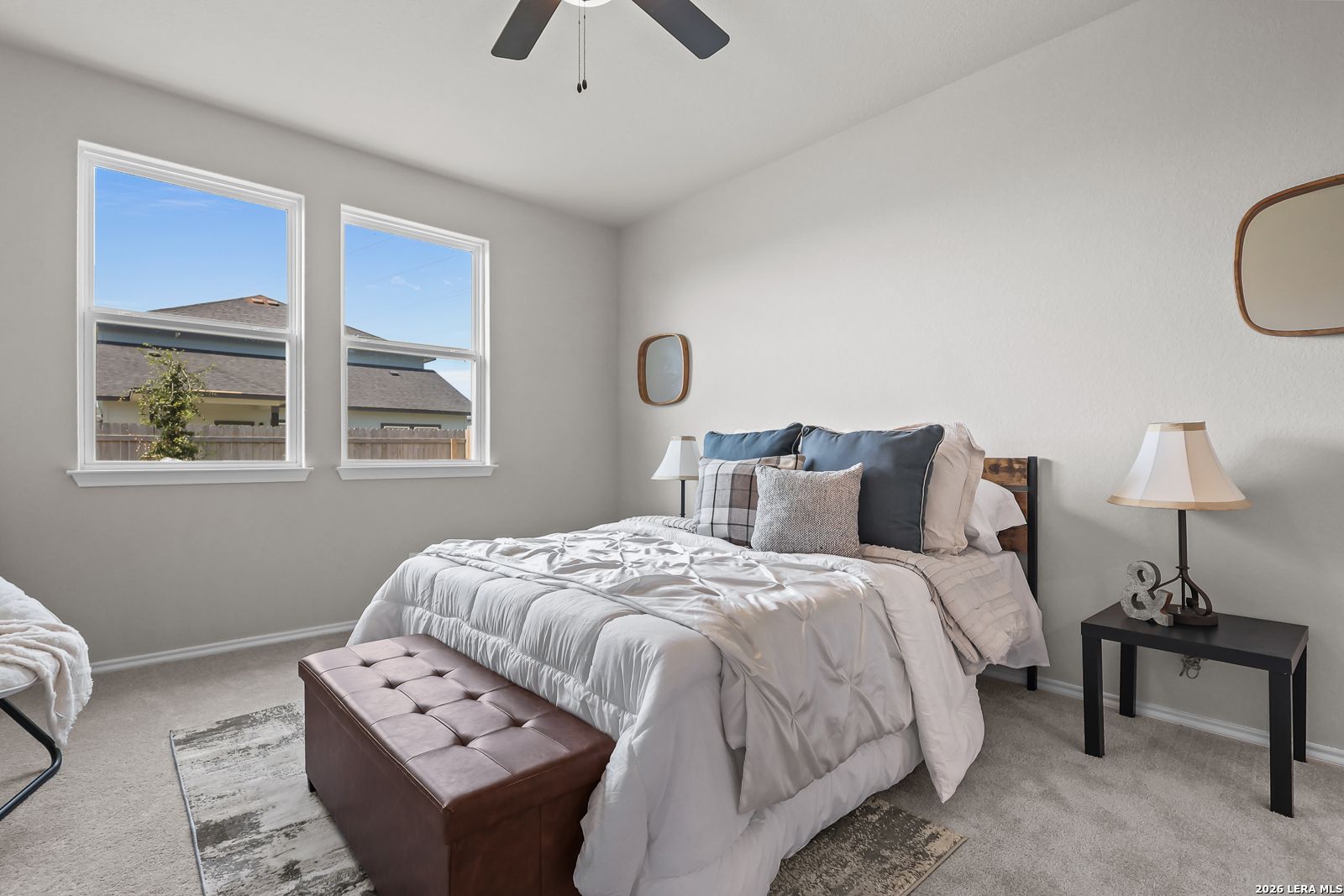 Bright, modern secondary bedroom with plush bedding in The Daphne H floor plan at Hannah Heights, Seguin, Texas.