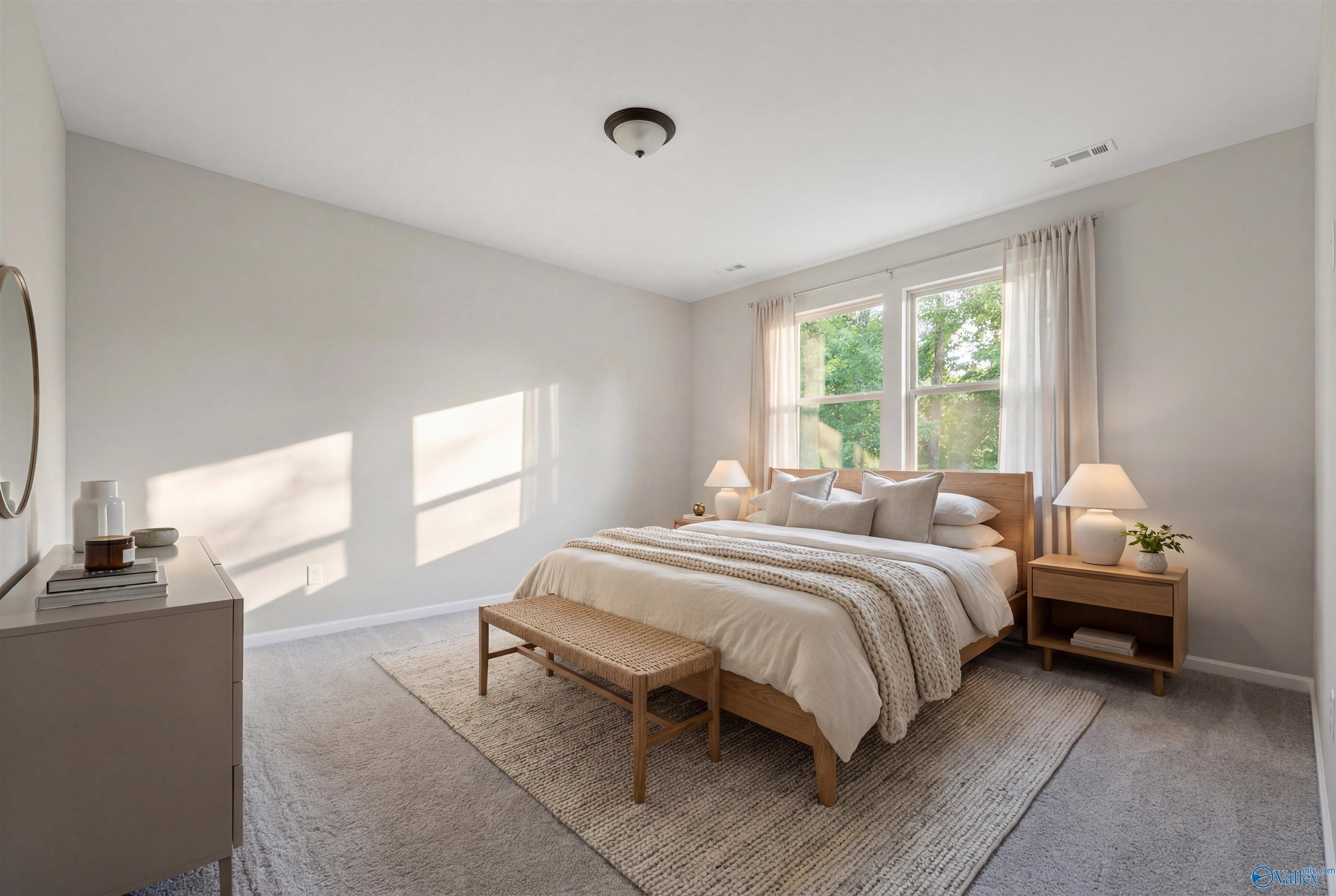Serene master bedroom with king bed, neutral tones, and natural light in Davidson Homes The Phoenix, Fayetteville, TN