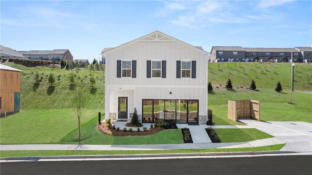 Two-story Craftsman home with white siding, black shutters, gabled roof, and covered porch in The Bluffs, Canton, Georgia by Davidson Homes