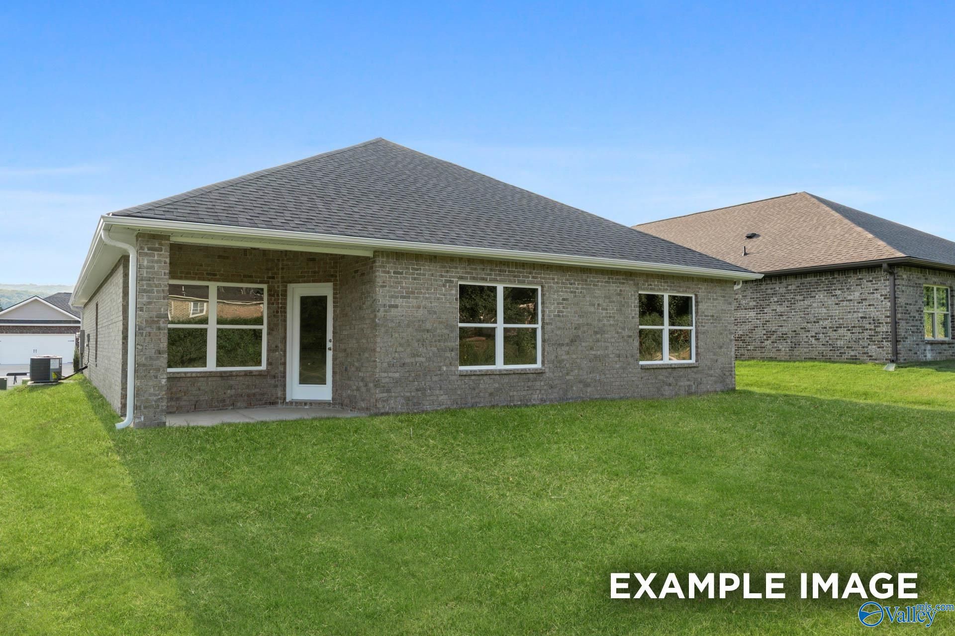 Brick single-story 4-bedroom home with covered porch, windows, and green lawn in Ivy Hills, Toney, Alabama by Davidson Homes The Daphne C