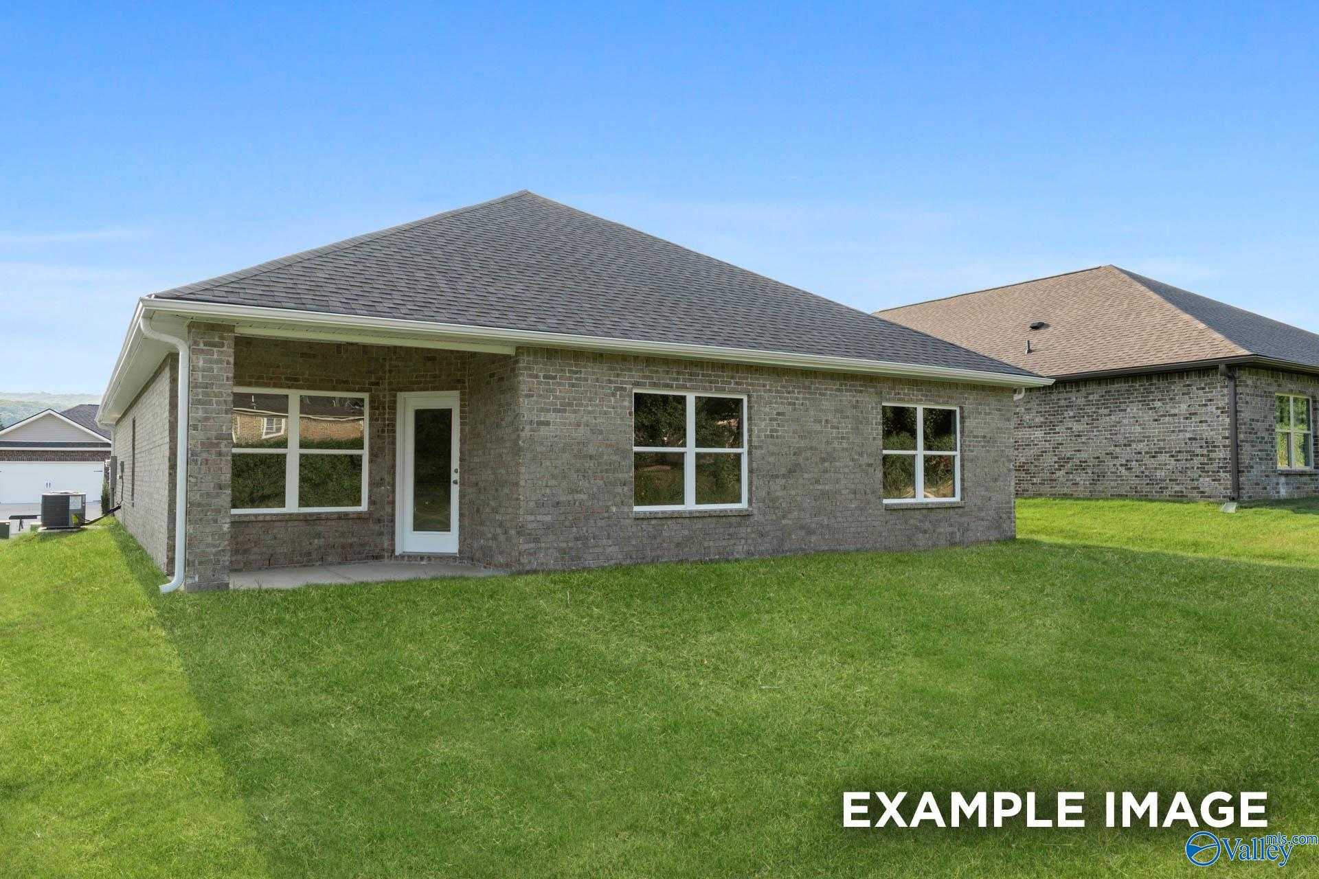 Brick single-story home with covered front porch, large windows, and green yard in Creek Grove, New Market, Alabama - Davidson Homes The Daphne C