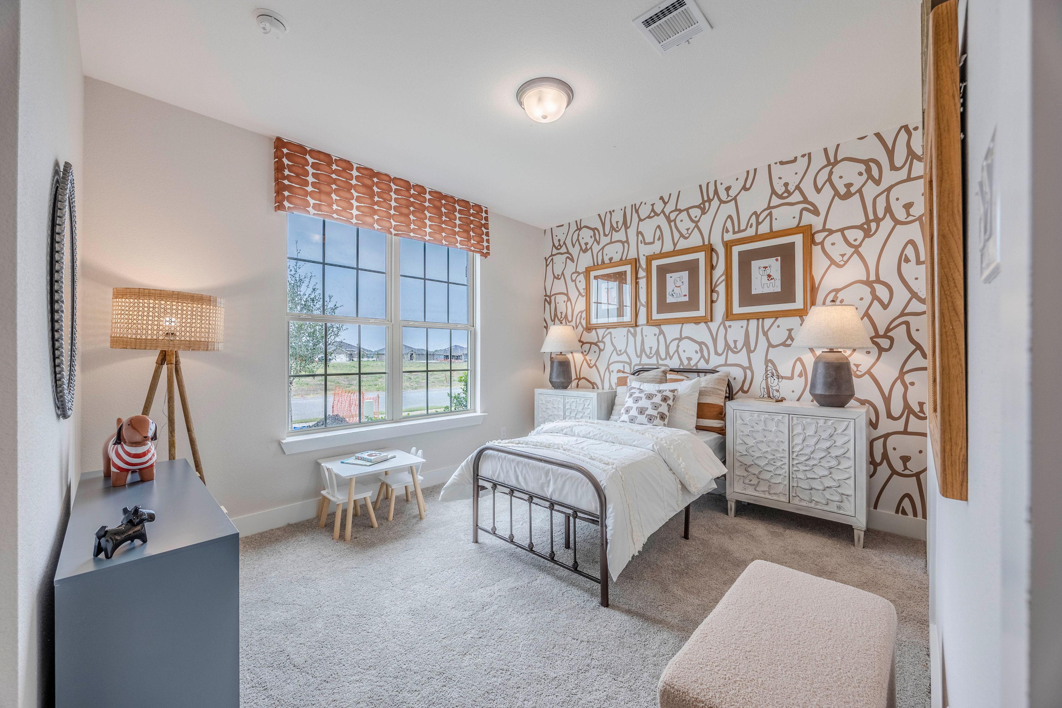 Children's bedroom at Waverly Estates in Josephine Texas featuring dog-patterned wallpaper, iron bed, toys, and large window