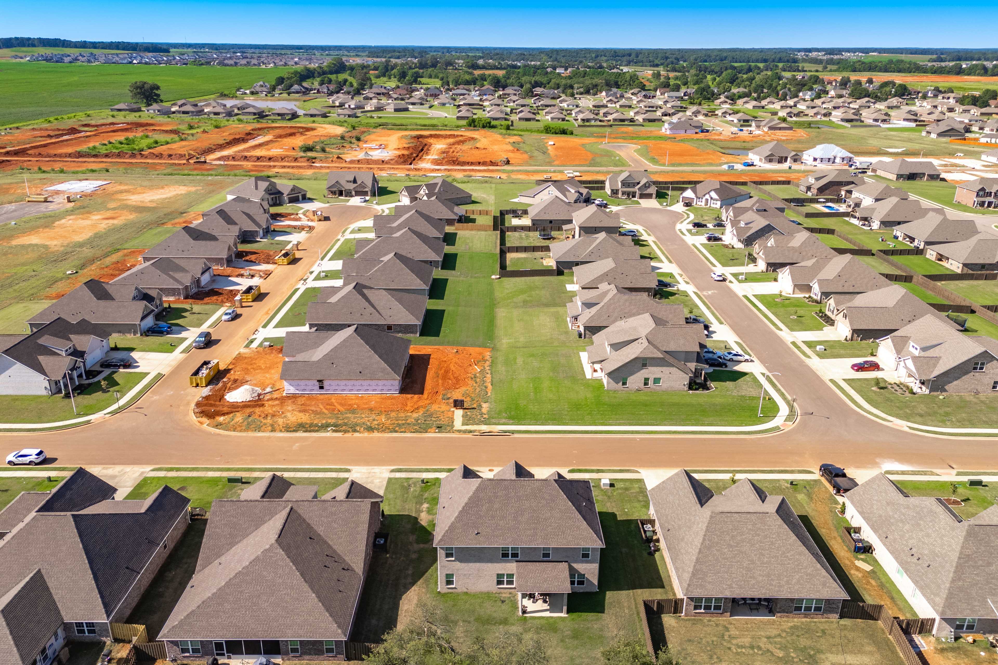 Aerial view of new homes under construction in Pikes Ridge, Meridianville Alabama by Davidson Homes with streets and surrounding fields